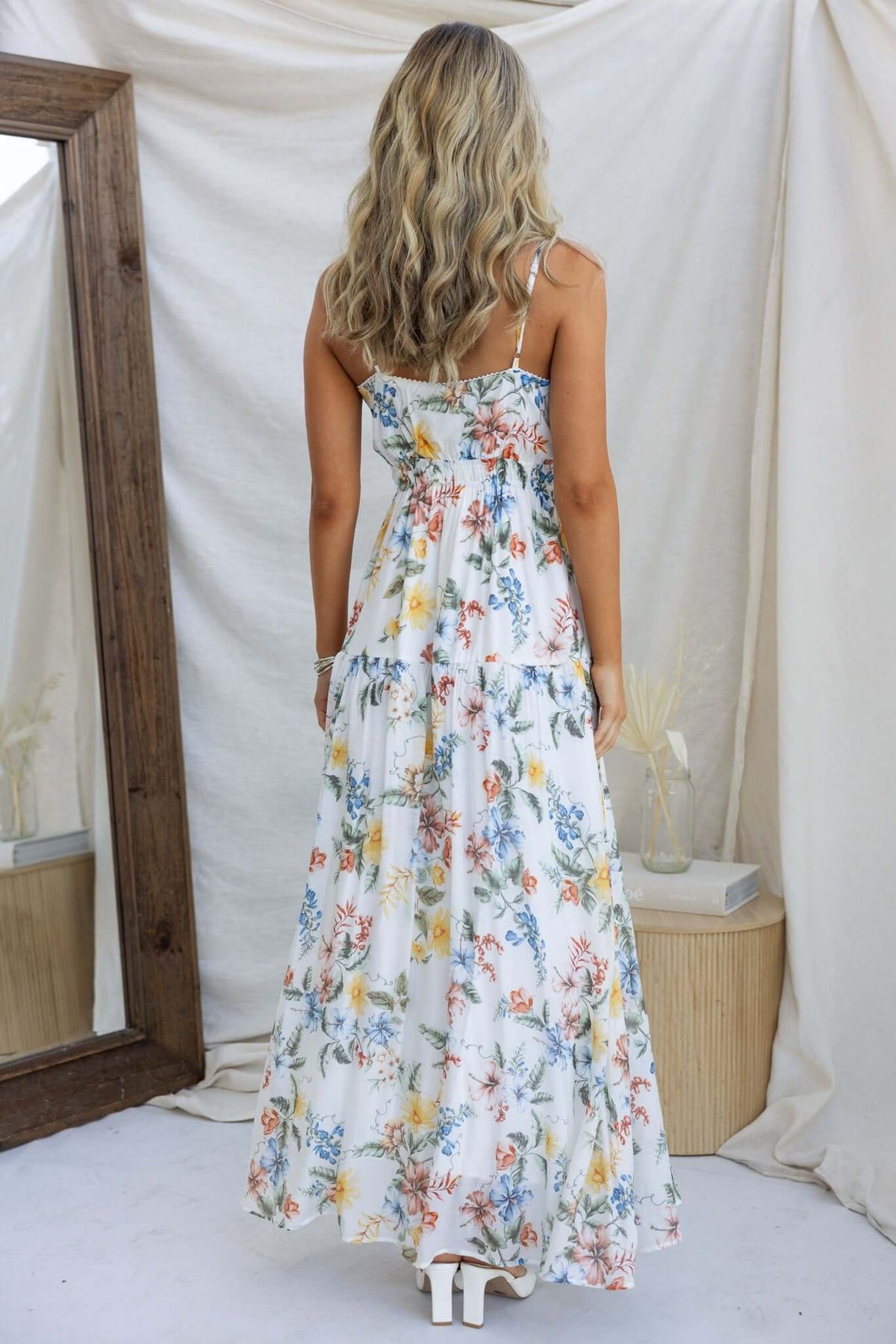 Back view of Garlyn maxi dress with floral print, adjustable straps, and tie detail at the bust.