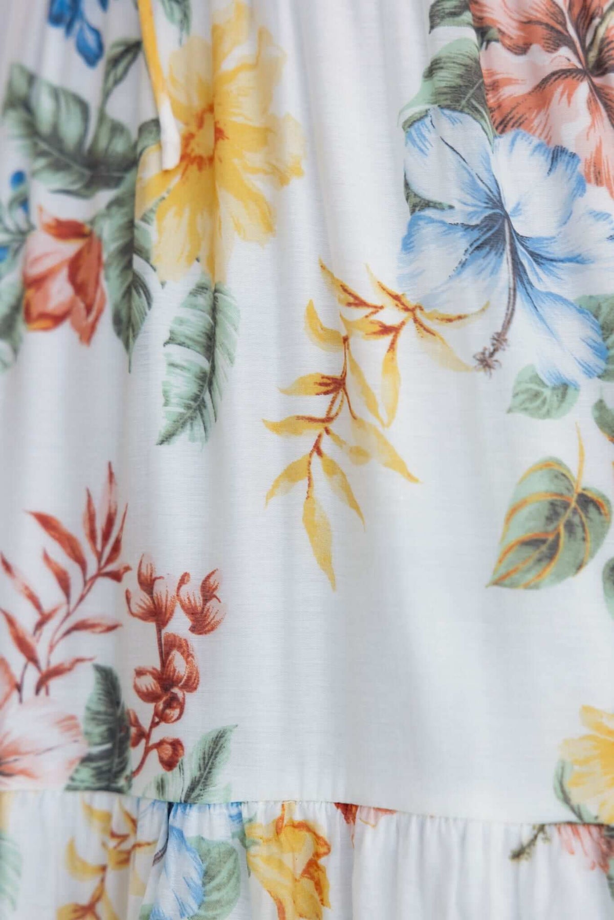 Close-up of floral pattern on Garlyn Maxi Dress featuring vibrant colors and tropical designs.