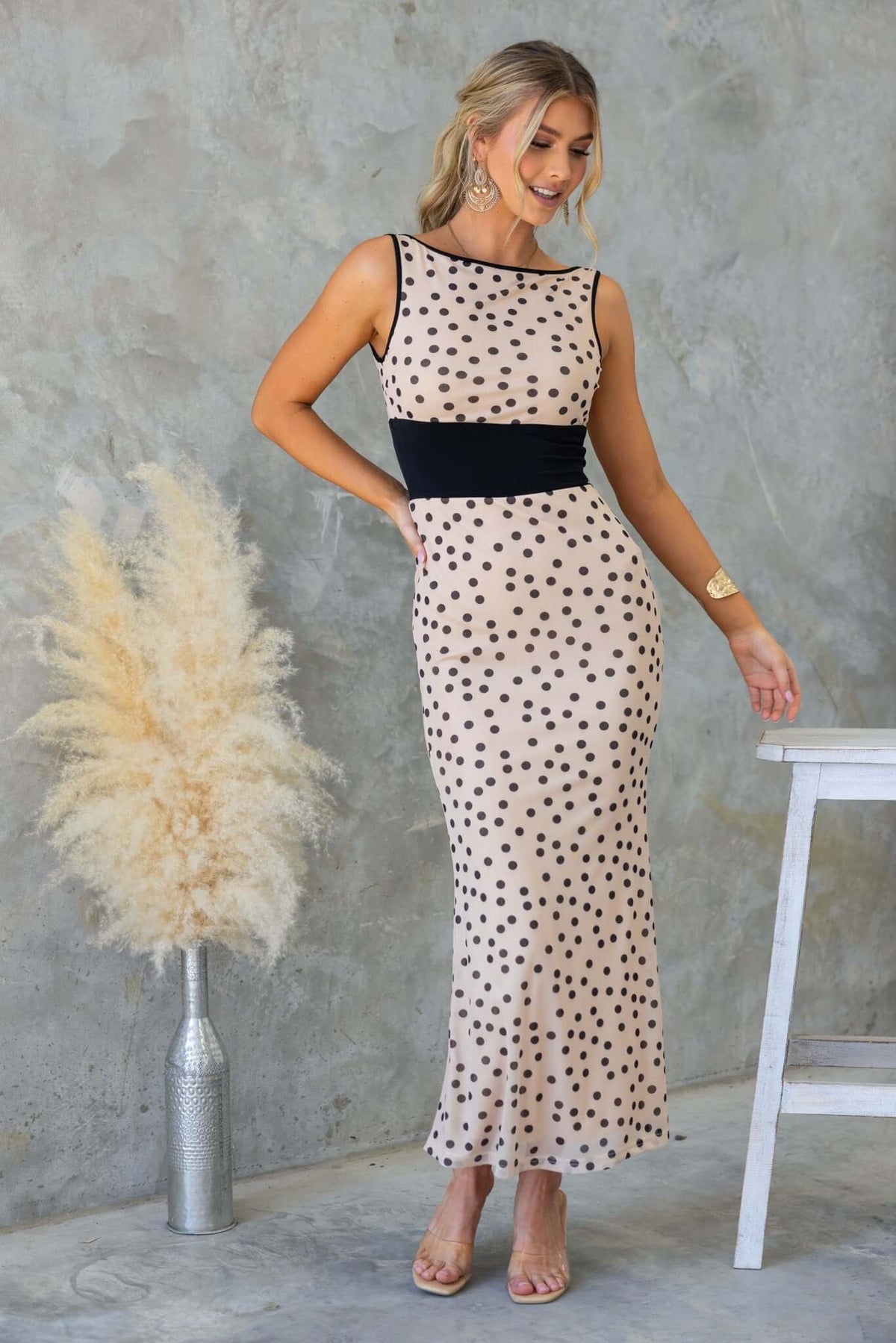 Loreto Maxi Dress in beige with black polka dots, featuring a boat neckline and fitted silhouette.