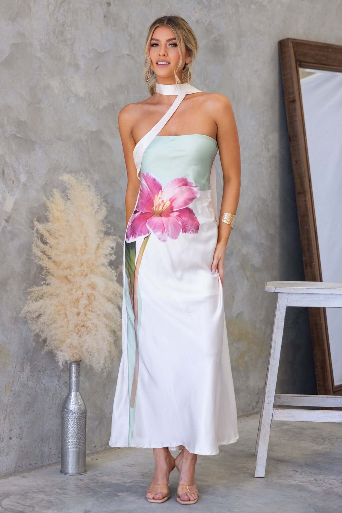 Model wearing My Touch Maxi Dress with floral print, side zip, satin feel, and removable strap, styled in a modern setting.