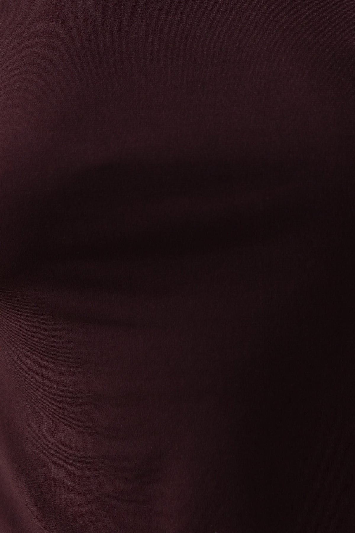 Close-up of fabric texture of Valery Top in deep burgundy, showcasing stretch material and smooth finish.