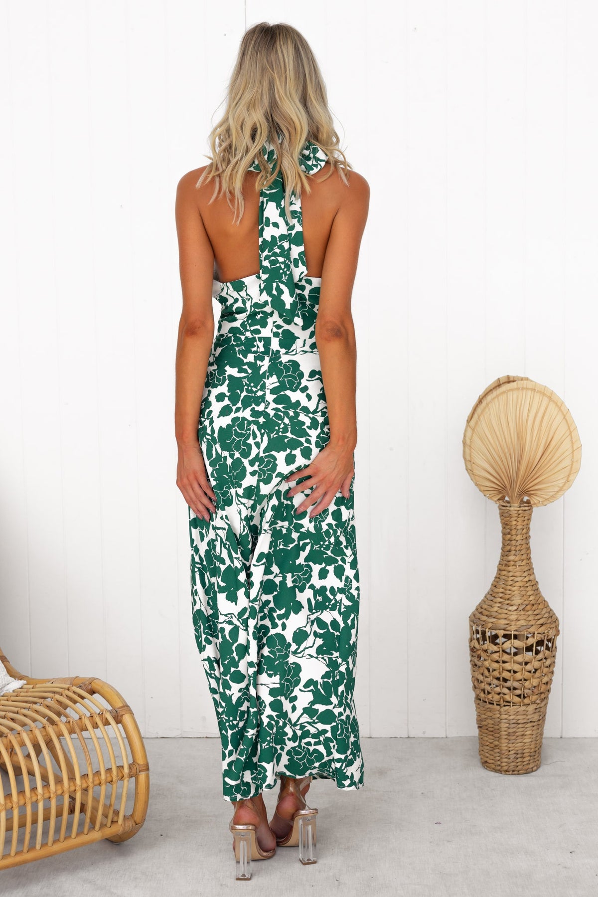 Back view of Renika floral maxi dress featuring adjustable tie neckline and twist detail at bust.