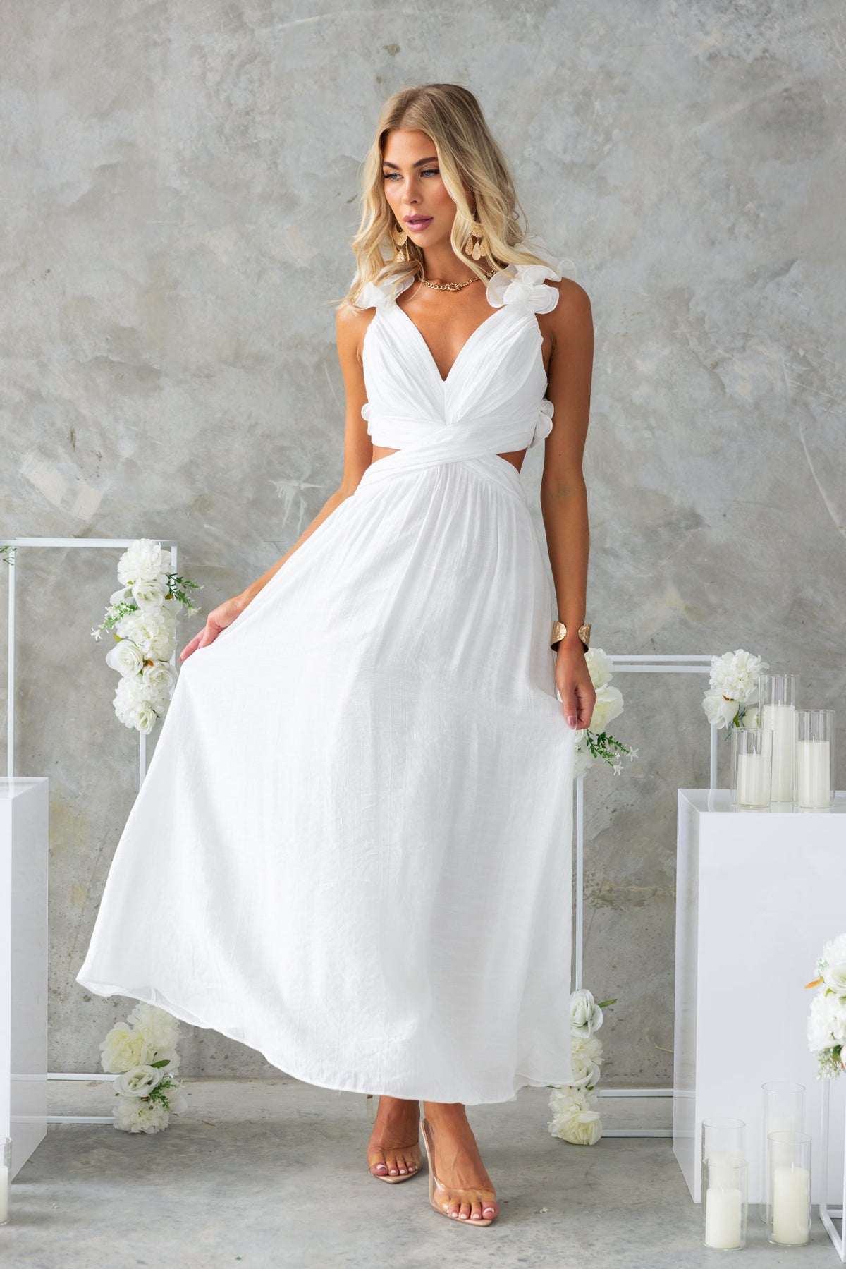 Luciana Maxi Dress featuring a V-neckline, ruffles, lace-up back, and cut-out waist in white chiffon.