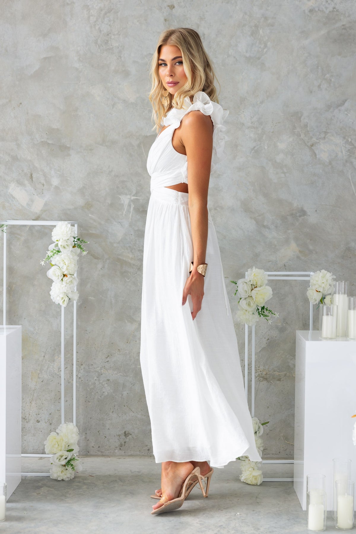 Luciana Maxi Dress in white featuring ruffle straps, V-neckline, and a stylish cut-out at the waist.