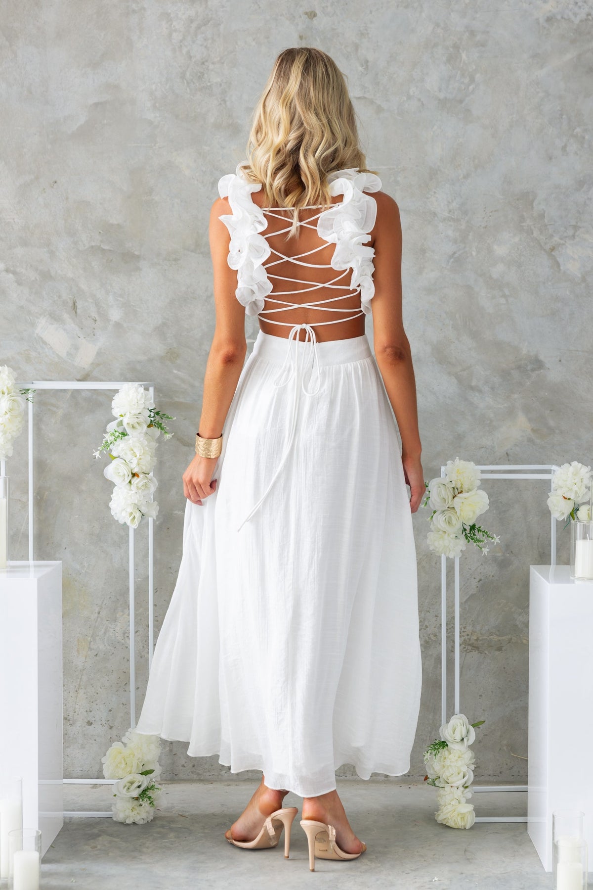 Back view of Luciana Maxi Dress featuring ruffle straps, lace-up tie, and a flowing white chiffon skirt.