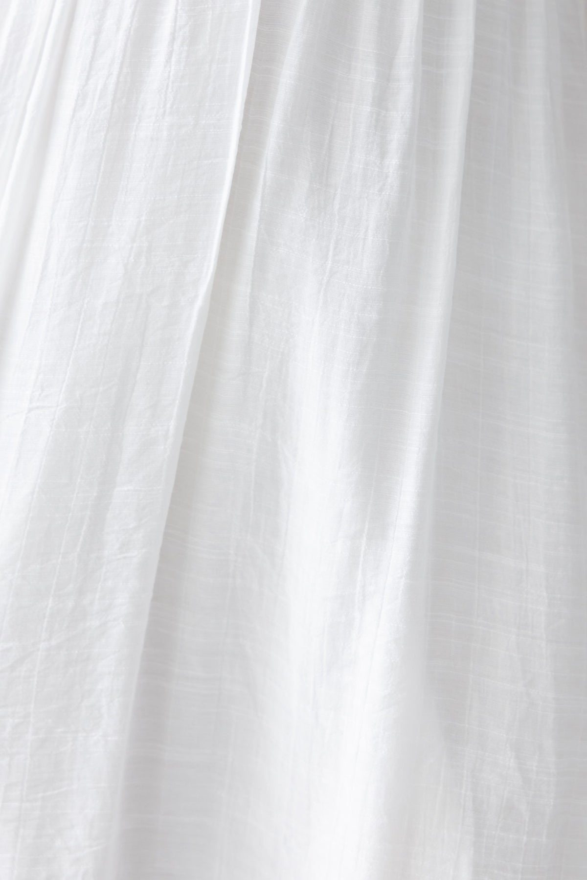 Close-up of lightweight white chiffon fabric of the Luciana Maxi Dress, showcasing its soft texture and flow.