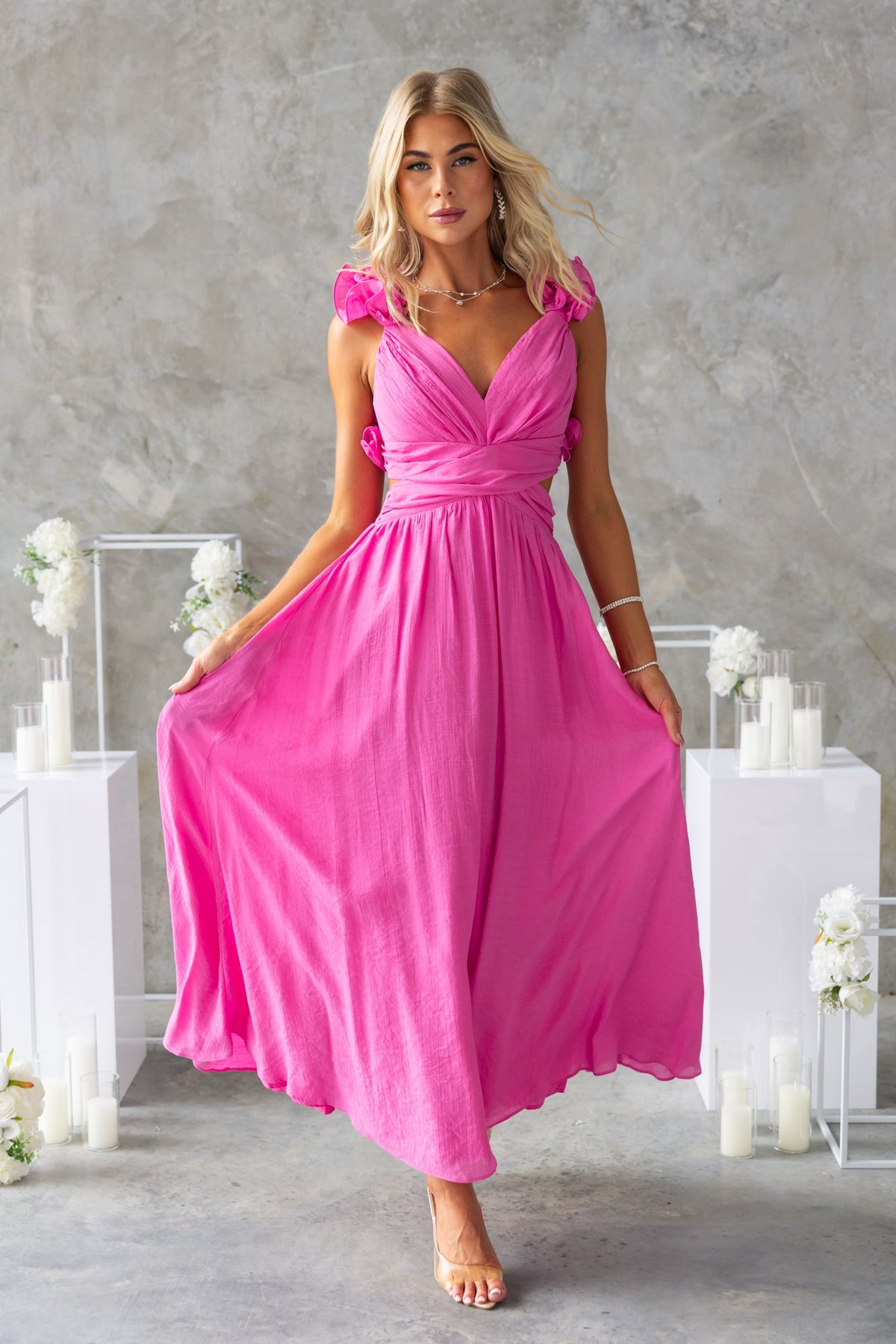 Luciana Maxi Dress in vibrant pink with ruffle straps, V-neckline, and flowy chiffon fabric. Perfect for summer events.