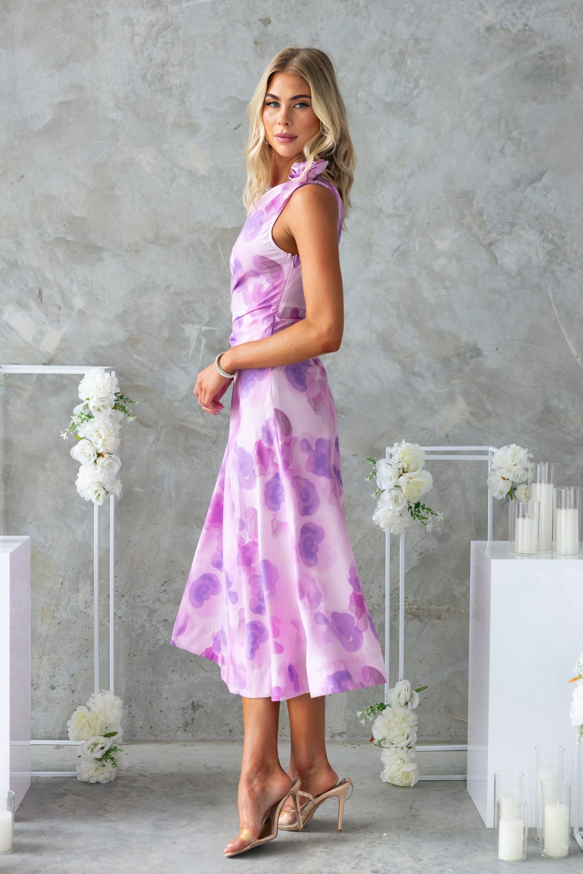 Model wearing Ikaris Midi Dress with floral print, one-shoulder neckline, and asymmetrical hemline.