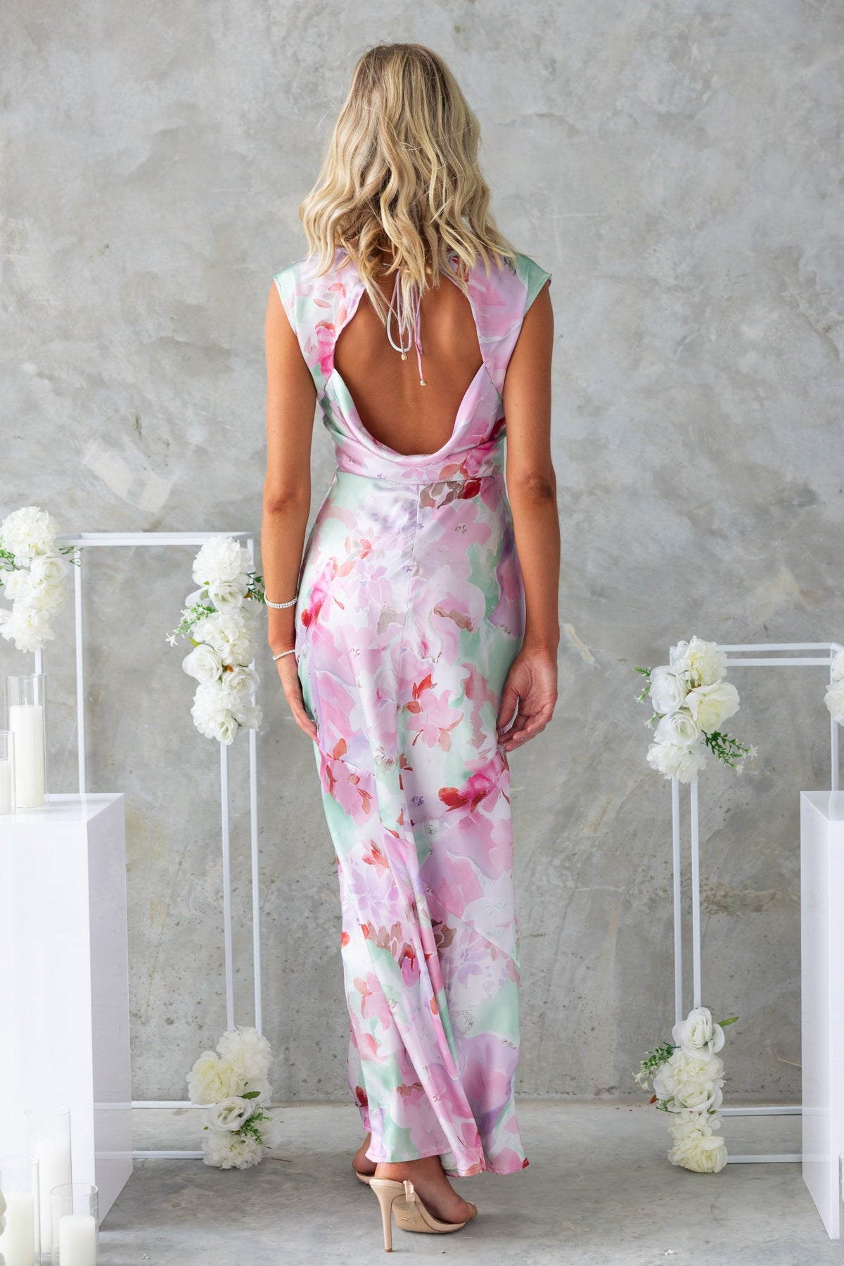 Back view of a floral print Bibi Maxi Dress showcasing boat neckline and tie detail at the back.