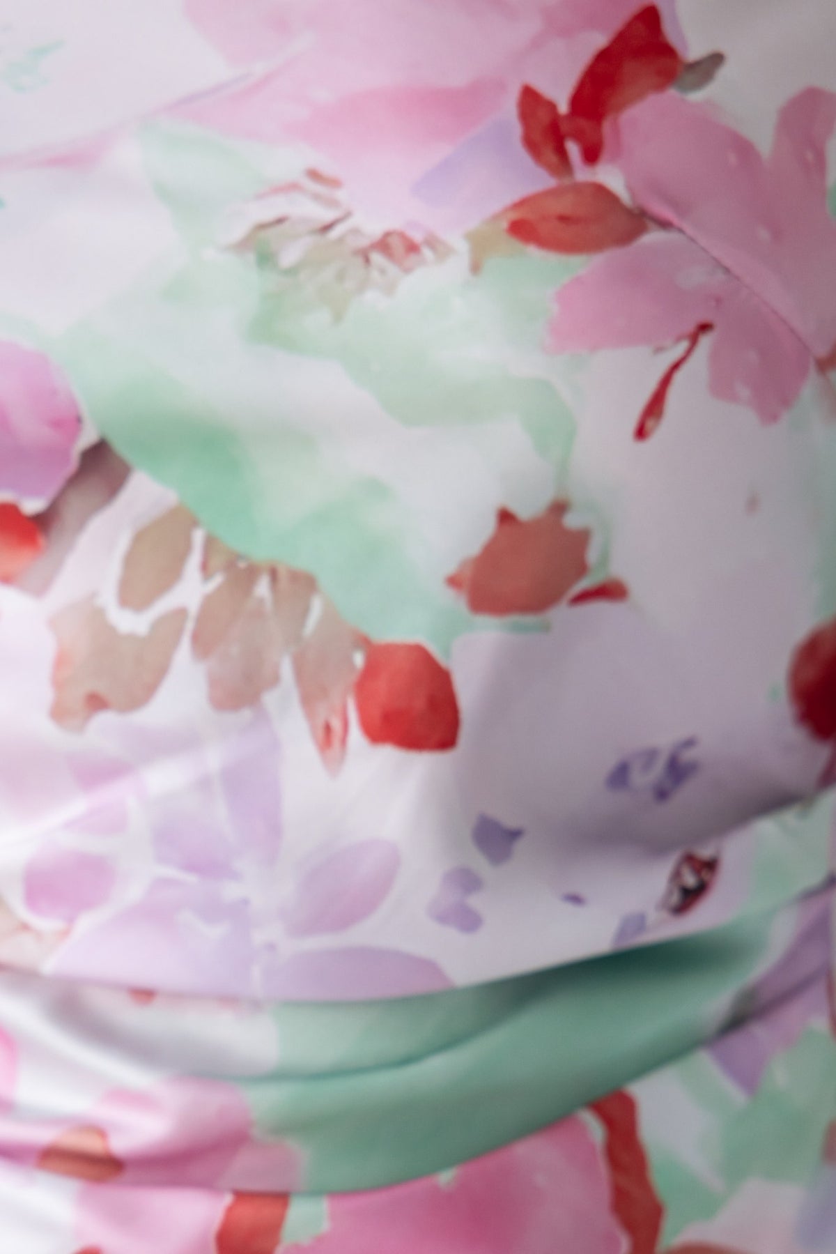 Close-up of floral print fabric featuring pink, green, and red hues, ideal for Bibi Maxi Dress.