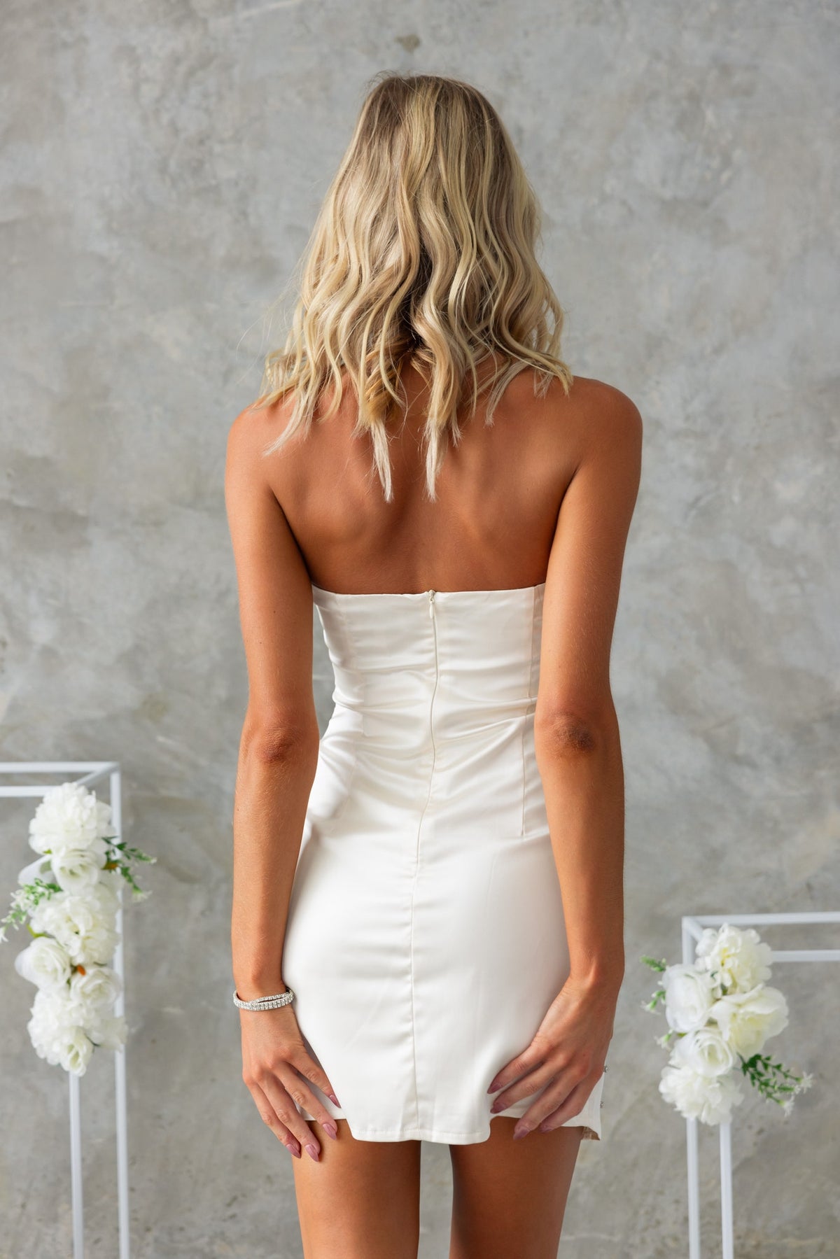 Back view of the Love More Dress, featuring a strapless design with a firm stretch and an invisible zip.