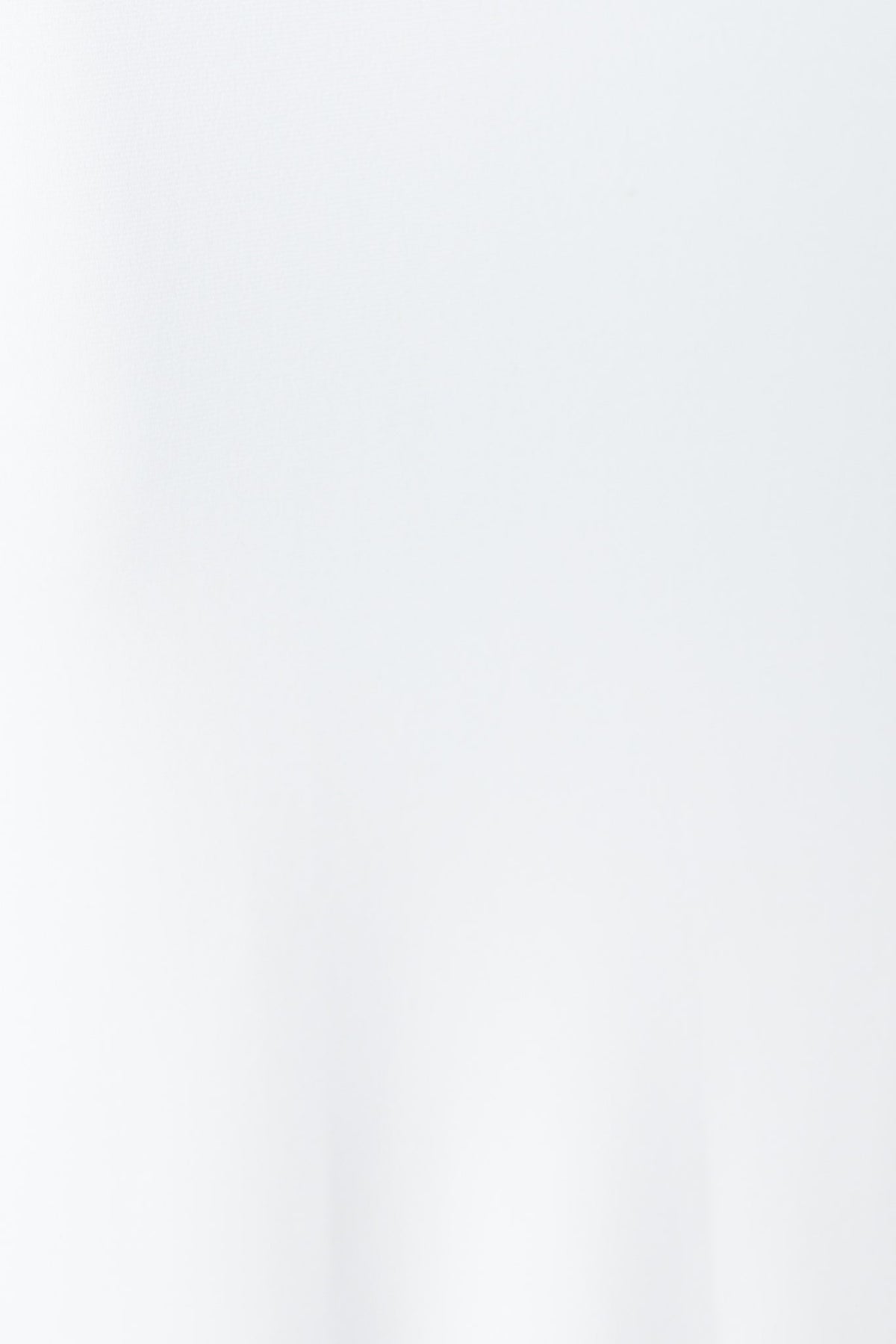 Valery Top in white featuring high neckline, side split, and asymmetric hemline for a stylish look.
