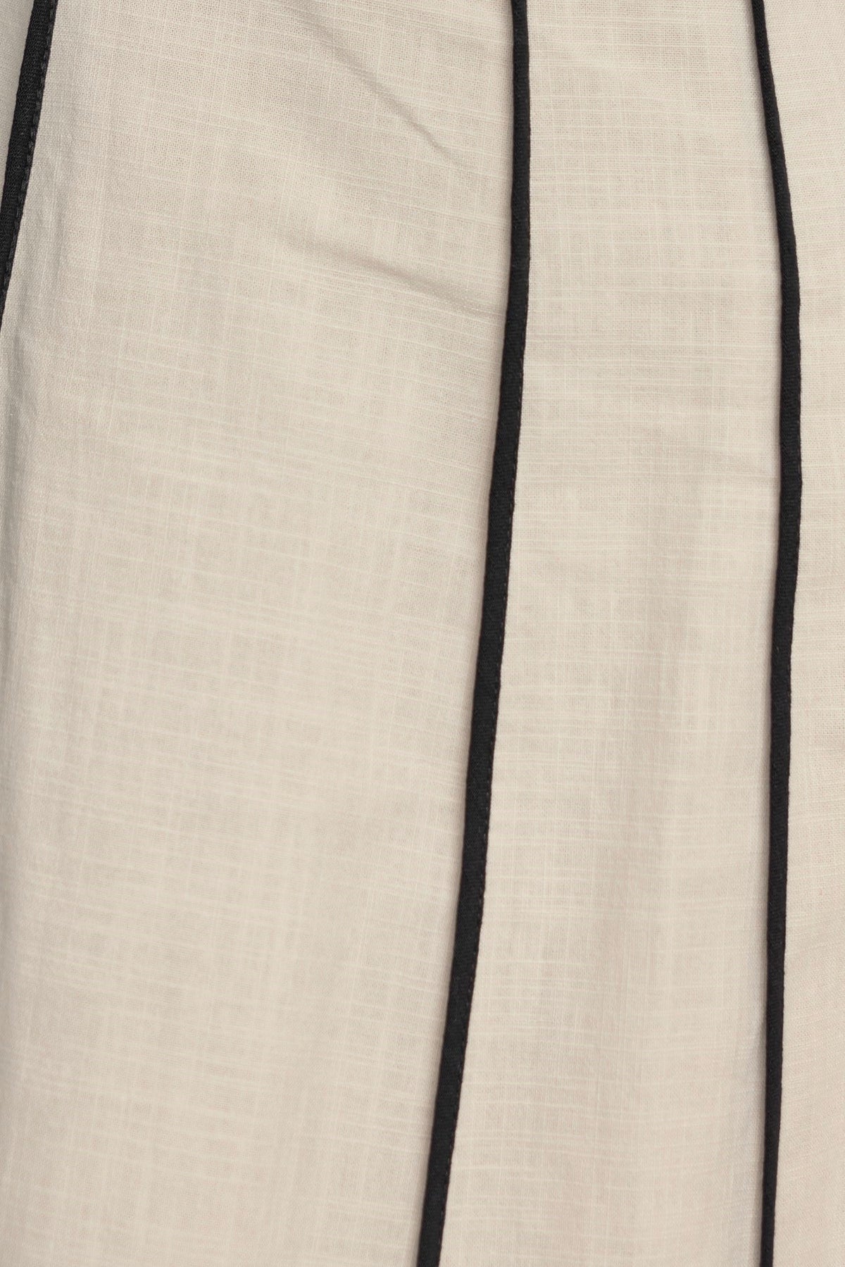 Close-up of Temila Midi Dress fabric showcasing linen texture and contrasting black lines.