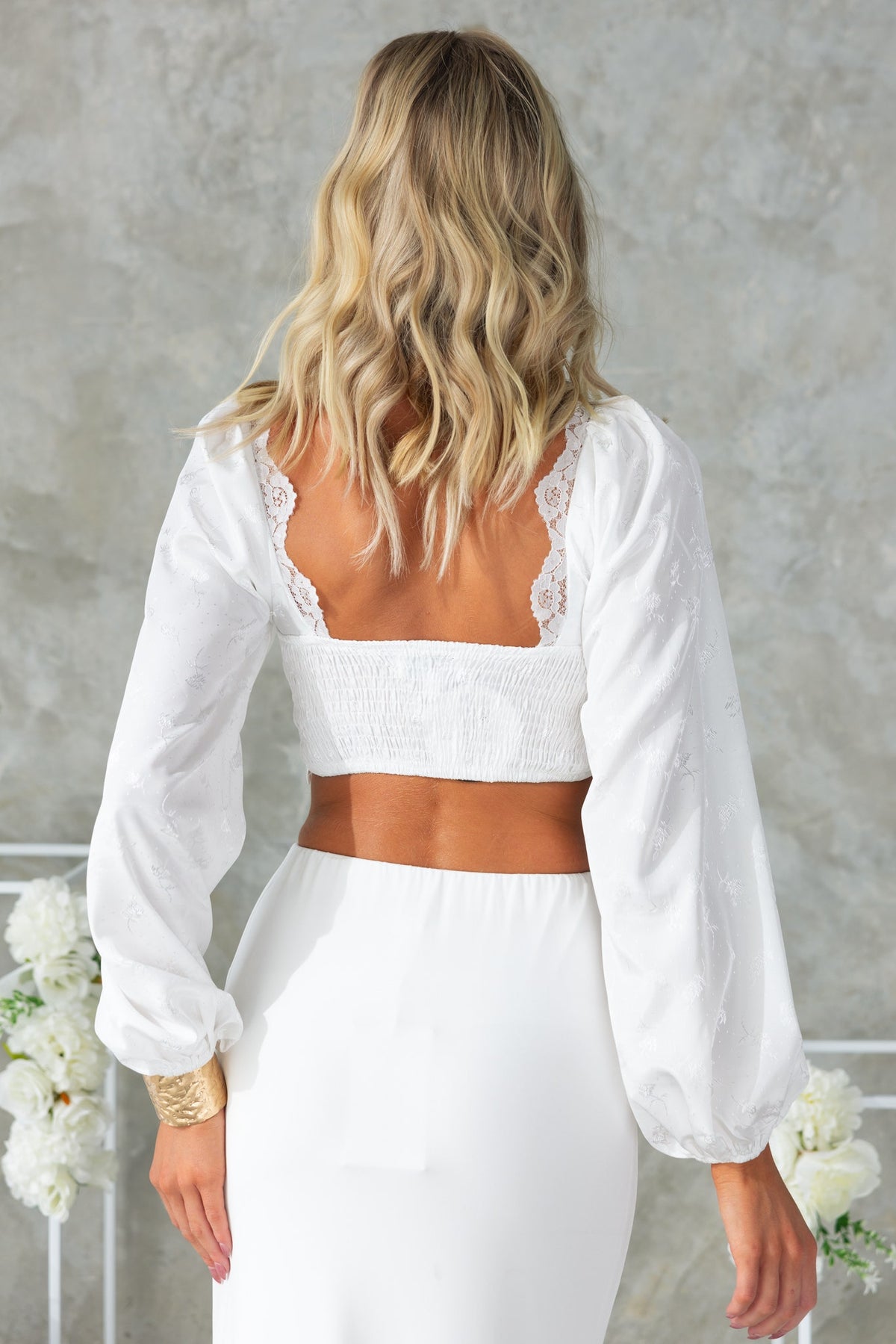 Back view of Balta Top with lace detailing and puff sleeves, featuring an elasticated back for a comfortable fit.
