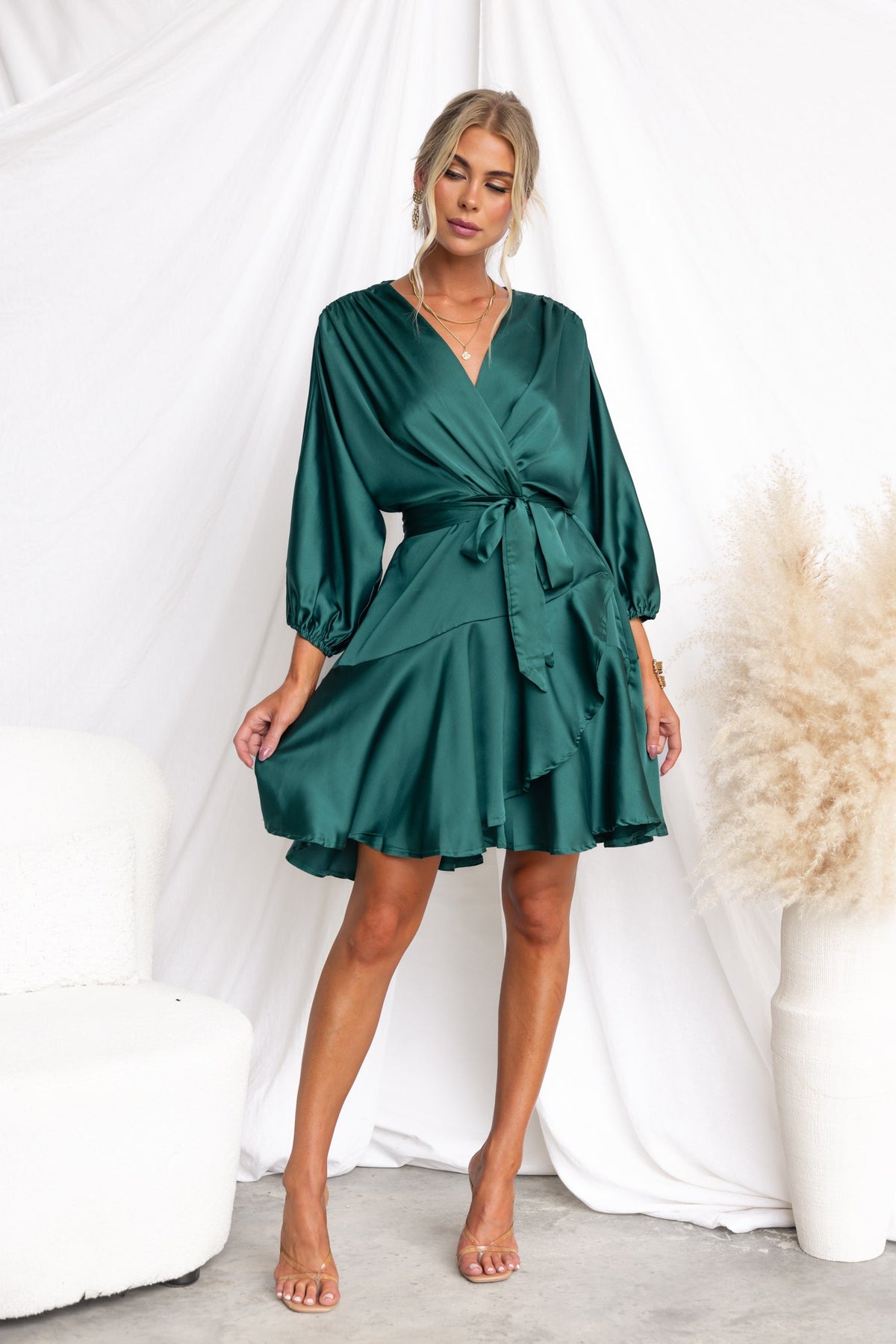 Xention Dress in green satin with V-neckline and batwing sleeves, featuring a removable belt and flared skirt.