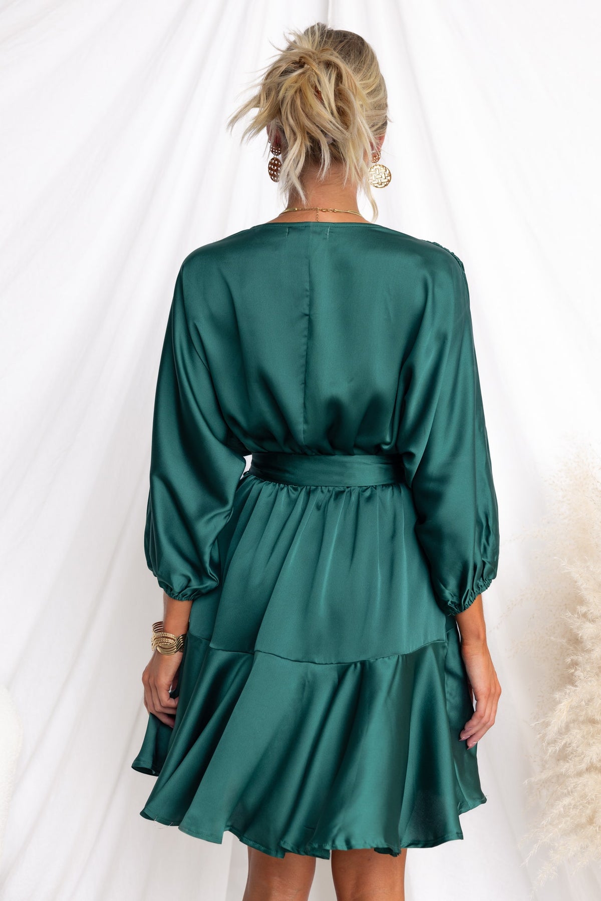 Back view of Xention Dress with V-neckline, batwing sleeves, and removable belt in rich green satin.
