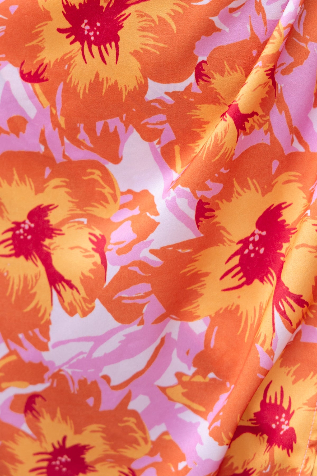 Close-up of vibrant orange and pink floral fabric pattern for the Fever Dream Dress.