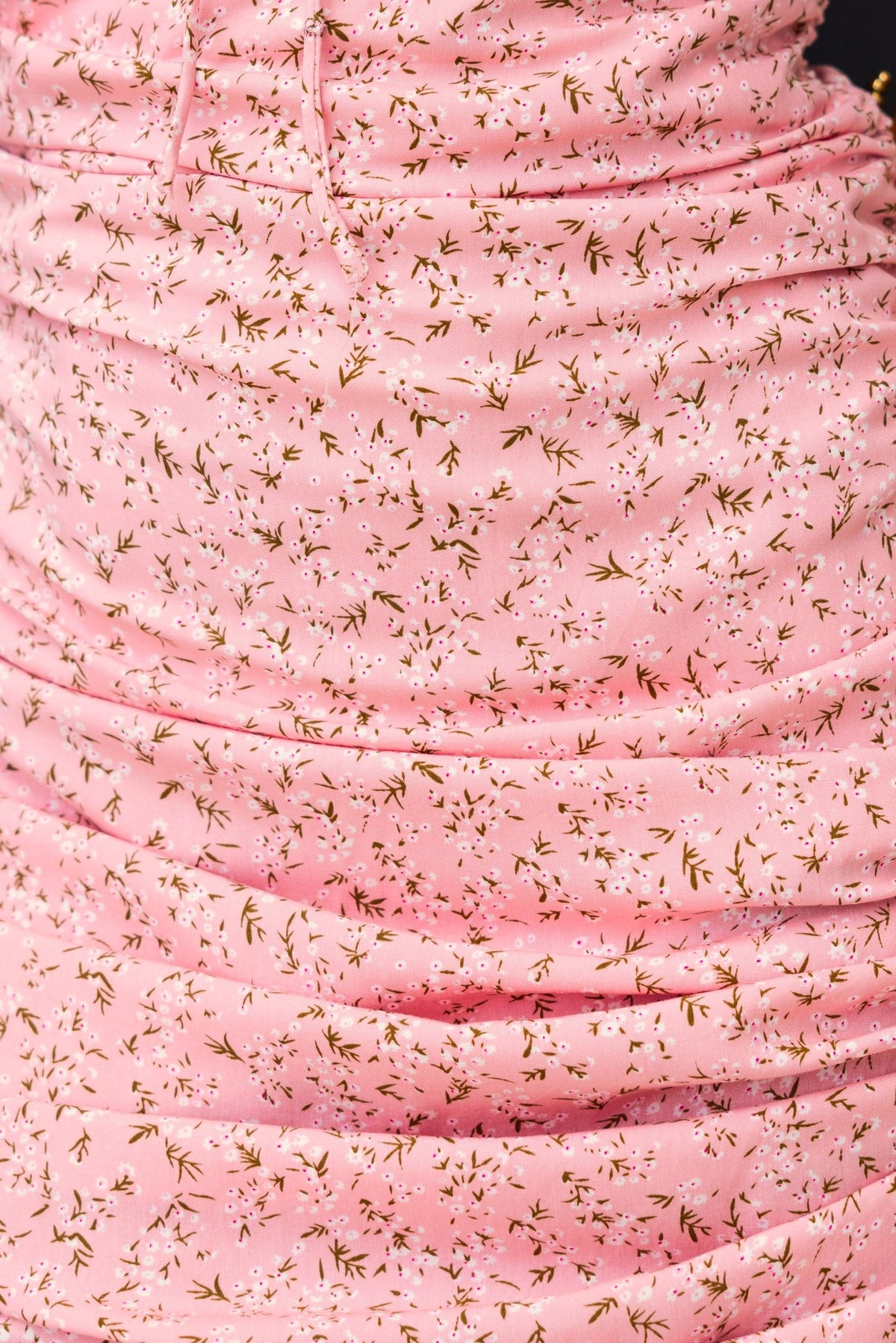 Close-up of pink floral print fabric with ruching on the Imelda Midi Dress, showcasing its elegant design.