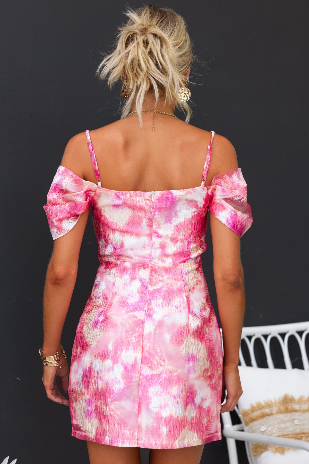 Back view of Danika Dress featuring adjustable straps, floral pink pattern, and fitted design.