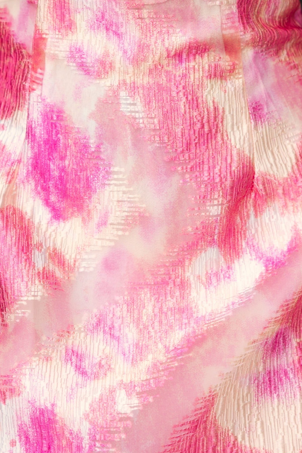 Close-up of Danika Dress fabric featuring a pink and cream floral pattern in lightweight chiffon material.