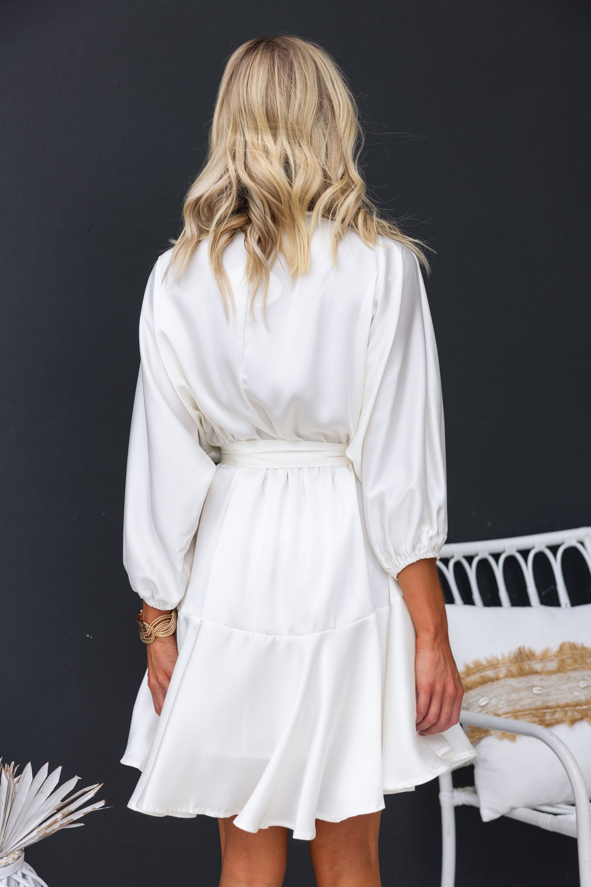 Back view of Xention Dress featuring batwing sleeves and removable fabric belt in a satin look.