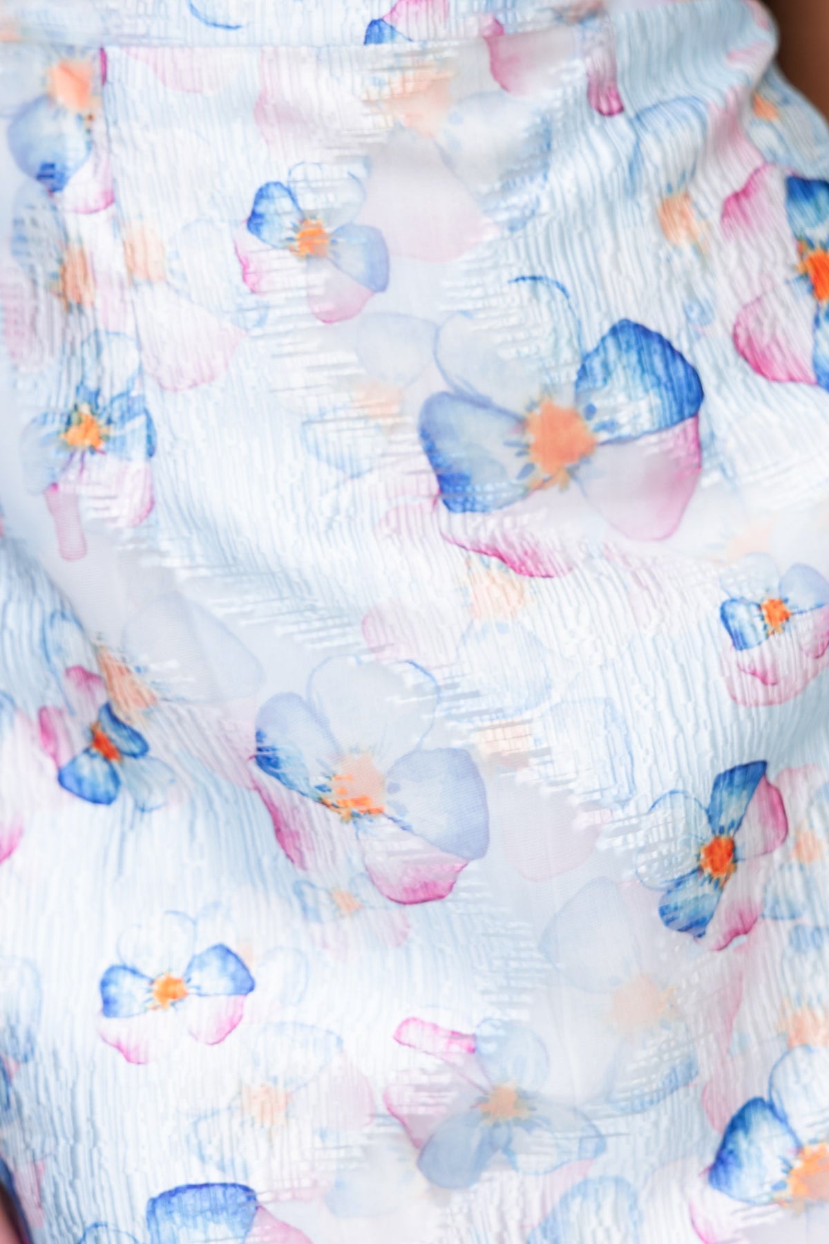 Close-up of floral chiffon fabric featuring pastel colors in a delicate pattern, highlighting the Danika Dress's elegant design.