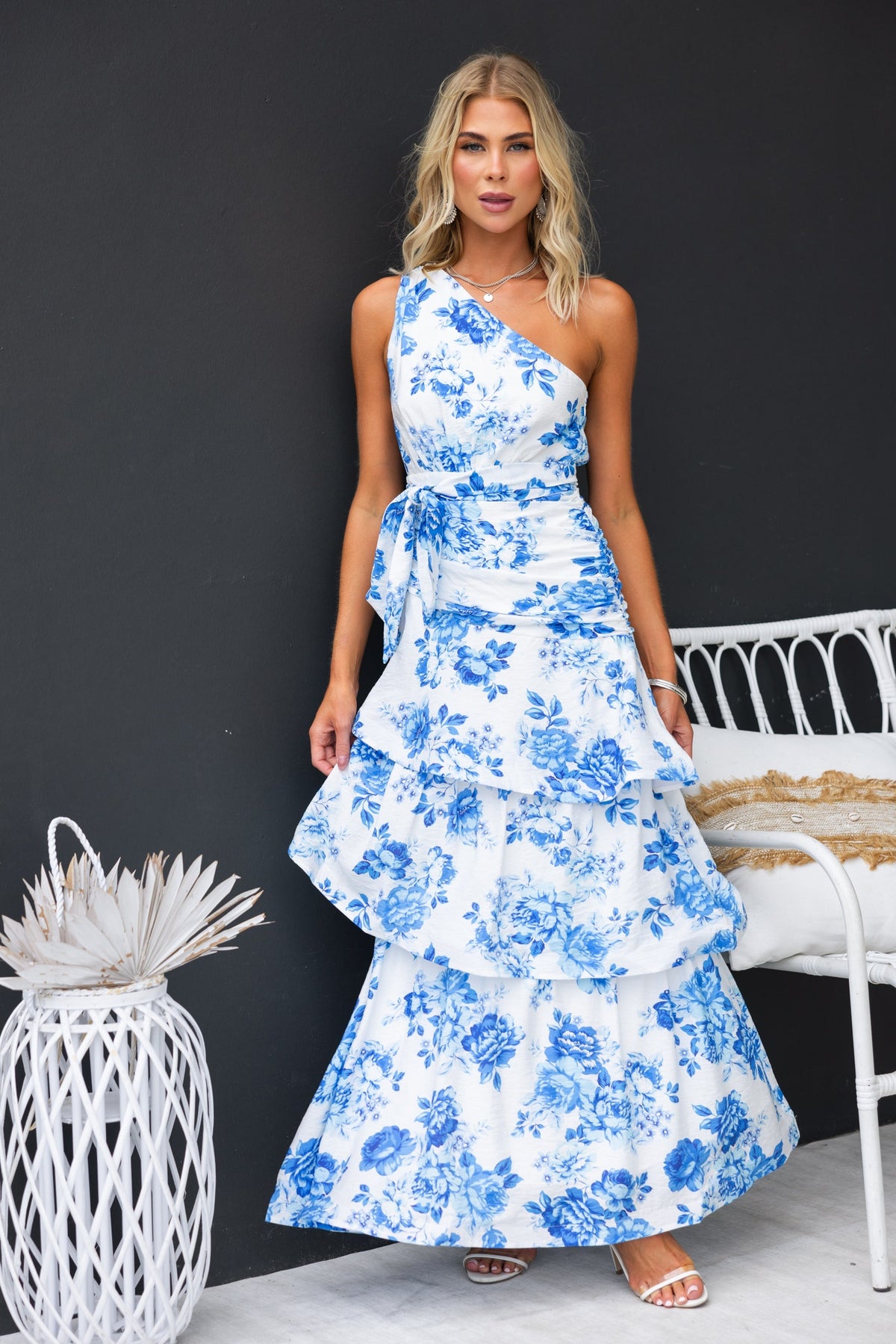 Ramsey Maxi Dress featuring blue floral print, one-shoulder neckline, removable fabric tie, and ruffle hem.