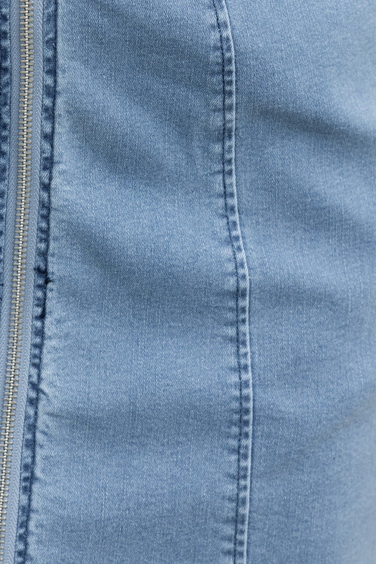 Close-up of the fabric on the Sloan Denim Dress showcasing its soft denim texture and zip-up detail.