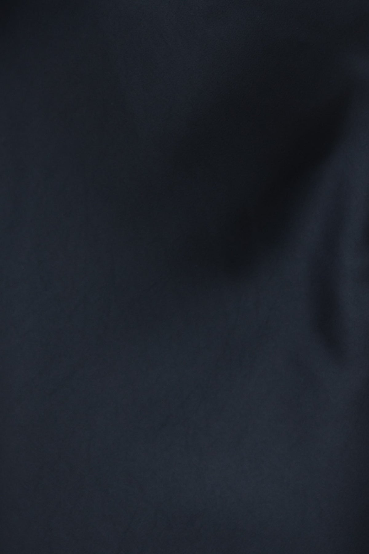 Close-up of black fabric with slight sheen, showcasing texture and color, perfect for an elegant maxi dress.