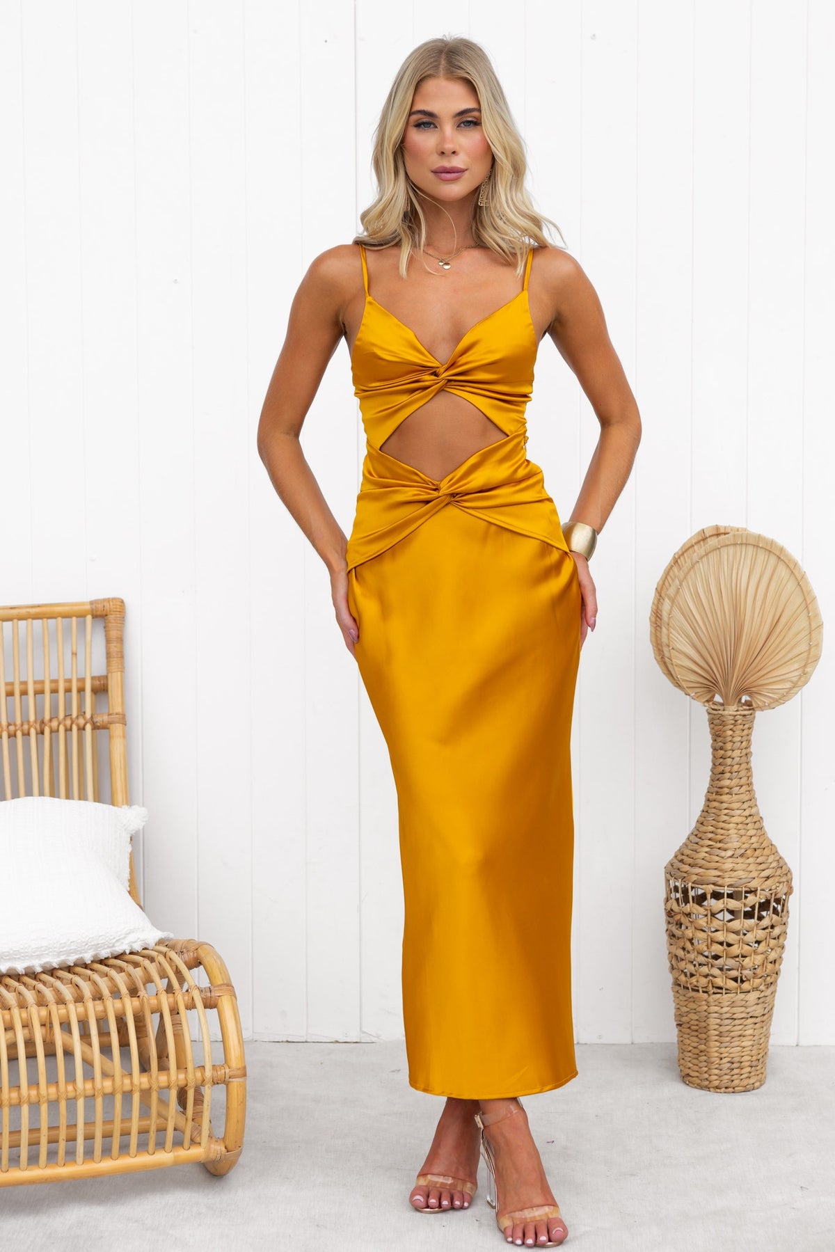 Alyna Maxi Dress in mustard yellow with adjustable straps, twist detail, and cut-out waist, styled for a chic look.