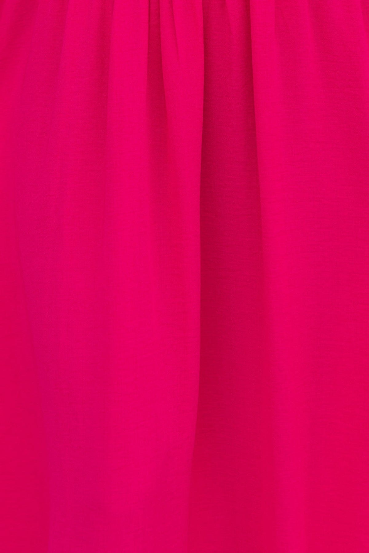 Close-up of vibrant pink fabric texture from Jayma Maxi Dress showcasing its soft drape and color.