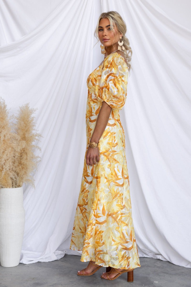 Samaya Maxi Dress in floral print with V-neckline, elastic sleeves, and a lined design, showcased against a white backdrop.