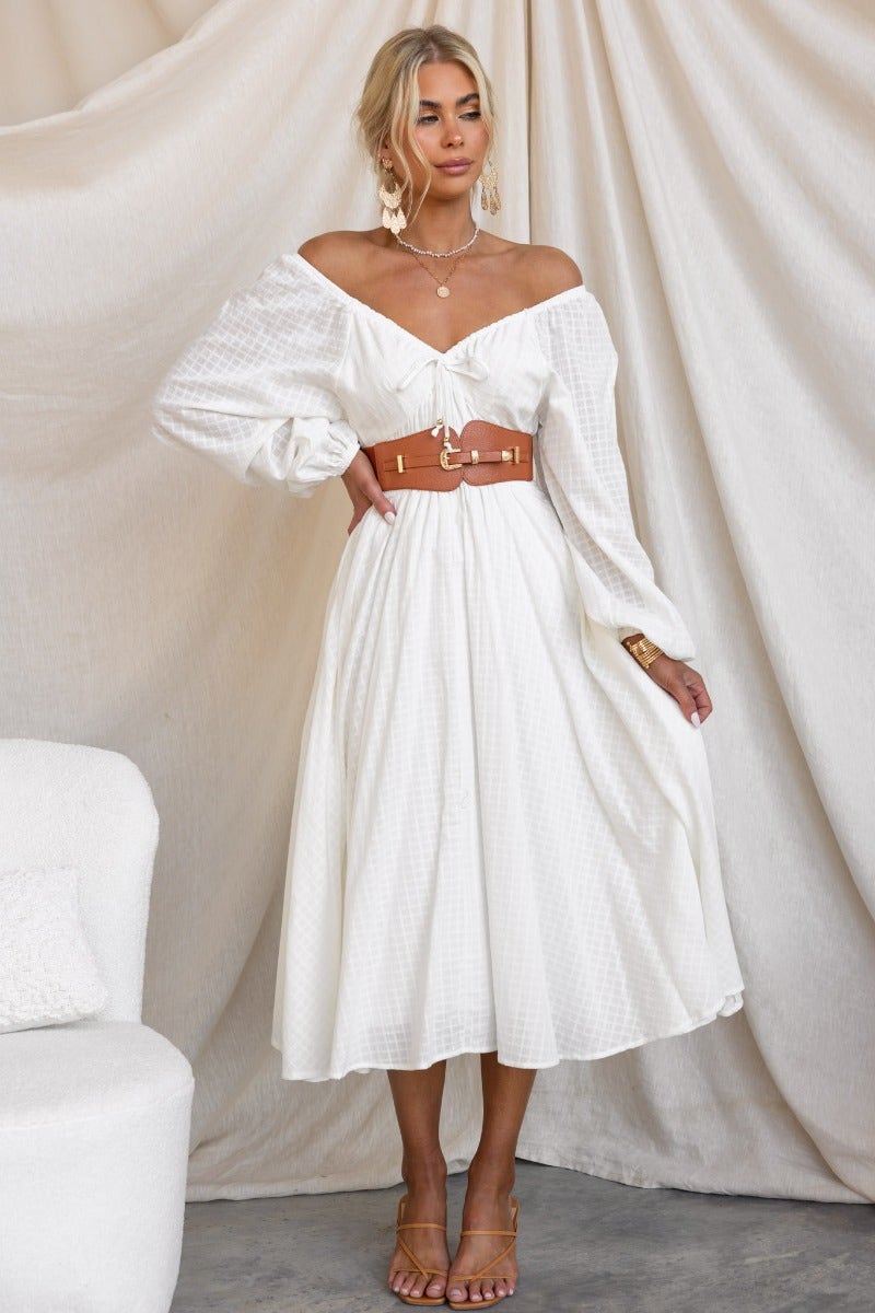 Model wearing a white off-the-shoulder dress styled with a Madden Belt featuring a gold hardware buckle.