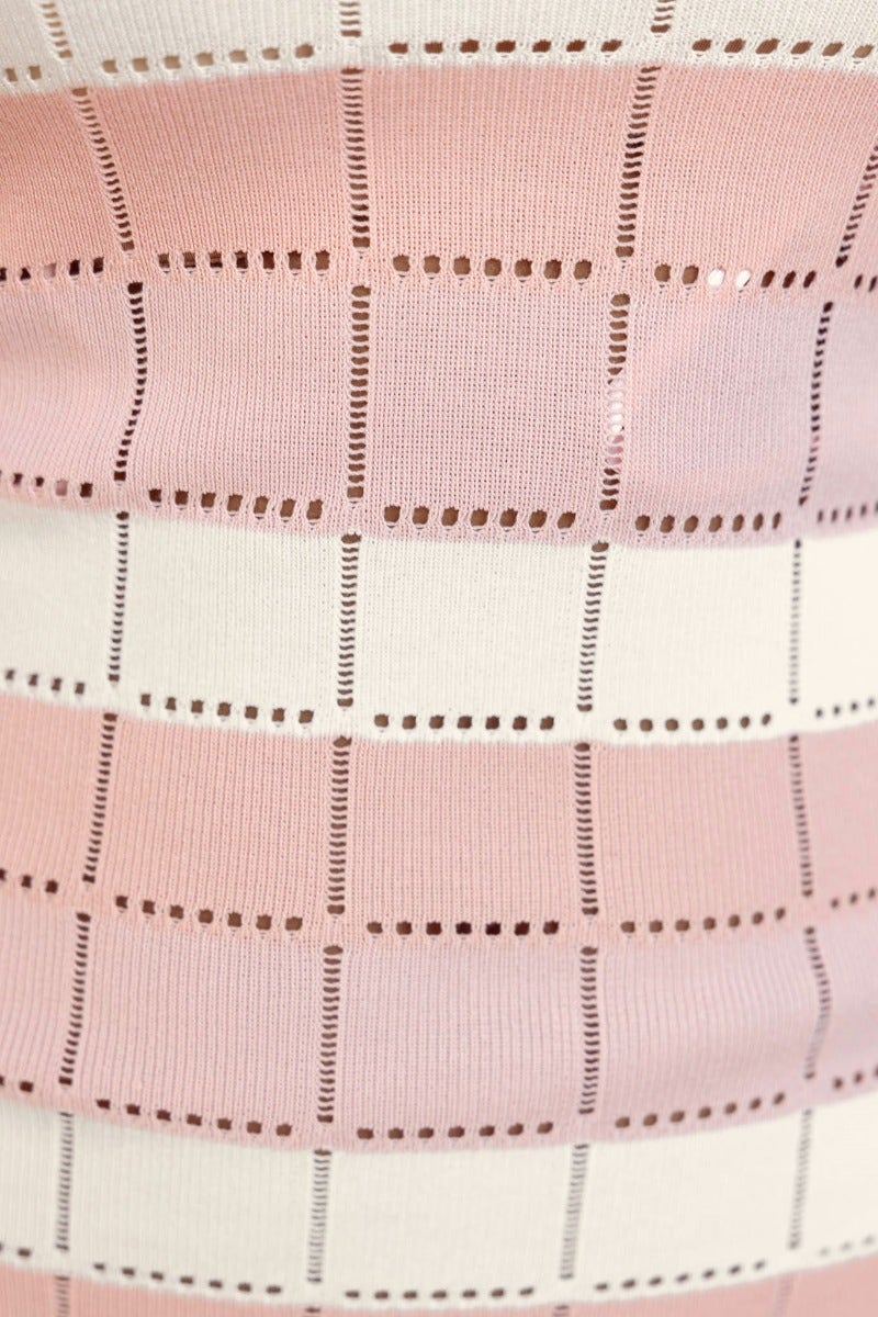 Close-up of Qaya Midi Dress fabric showing pink and white open knit pattern with unique design.