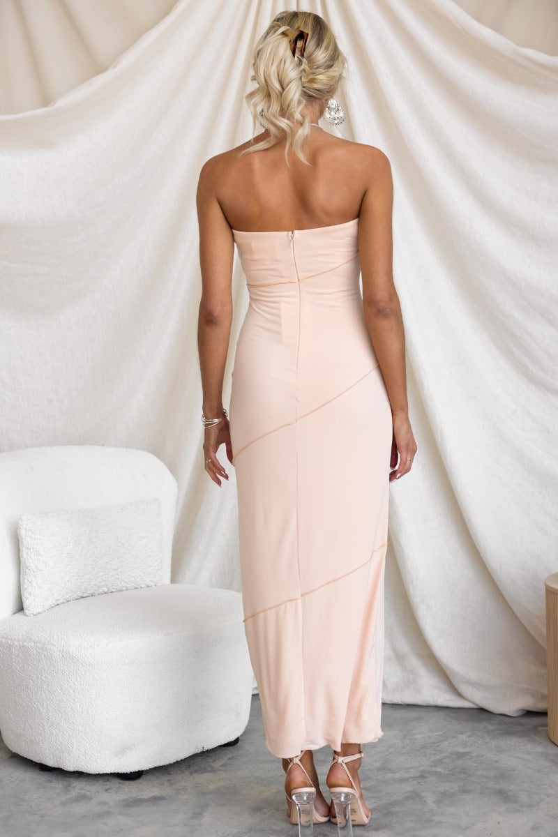 Back view of strapless Kaitey Maxi Dress in peach, showcasing anti-slip bust and invisible zip detail.