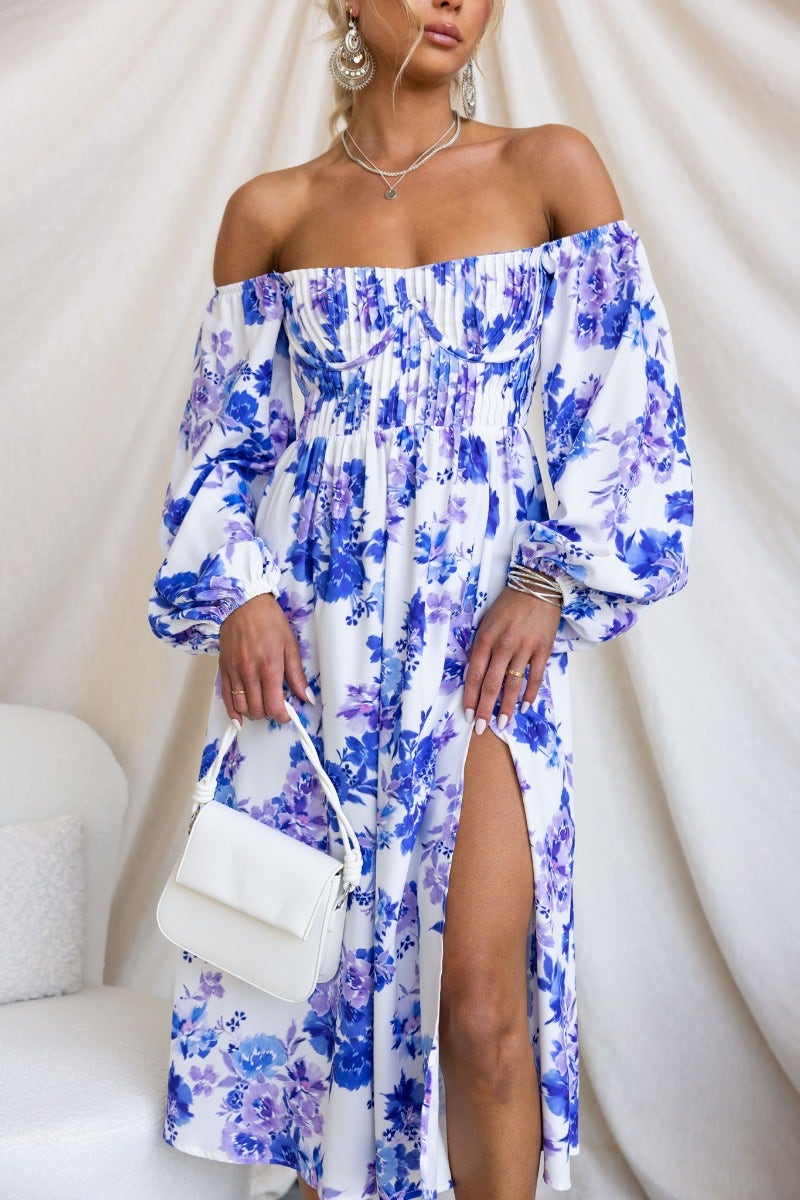 Floral off-shoulder Lost Love Midi Dress with pleat and front split, styled with a white handbag.