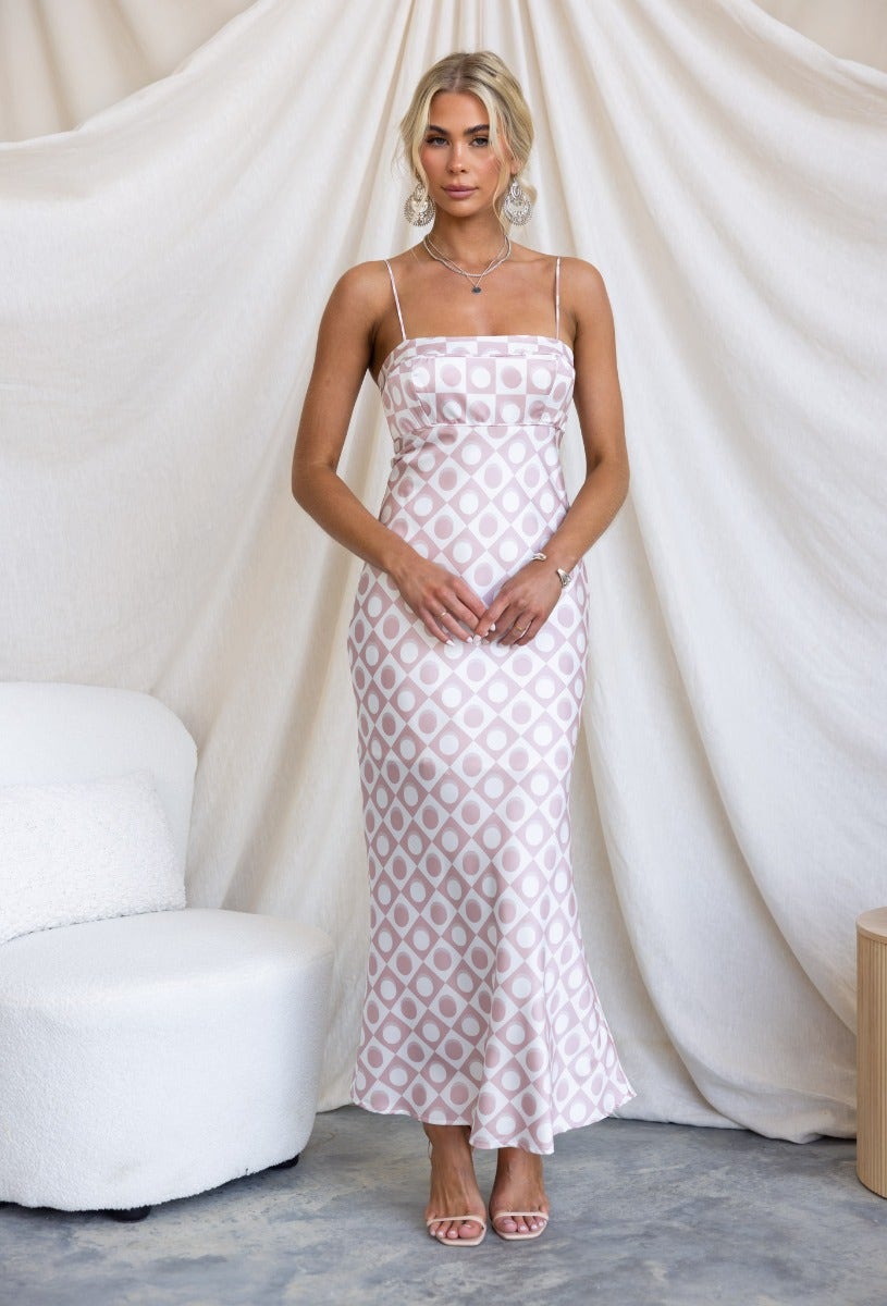 Wishart Maxi Dress in satin with adjustable straps and geometric print, styled on model against cream backdrop.