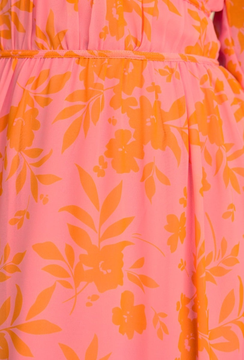 Close-up of floral print on the Jeanie Maxi Dress featuring pink and orange hues.