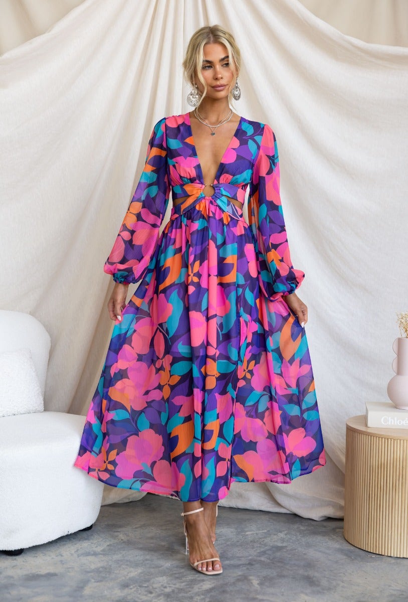 Romina Maxi Dress featuring vibrant floral print, V-neckline, and elegant split detailing.