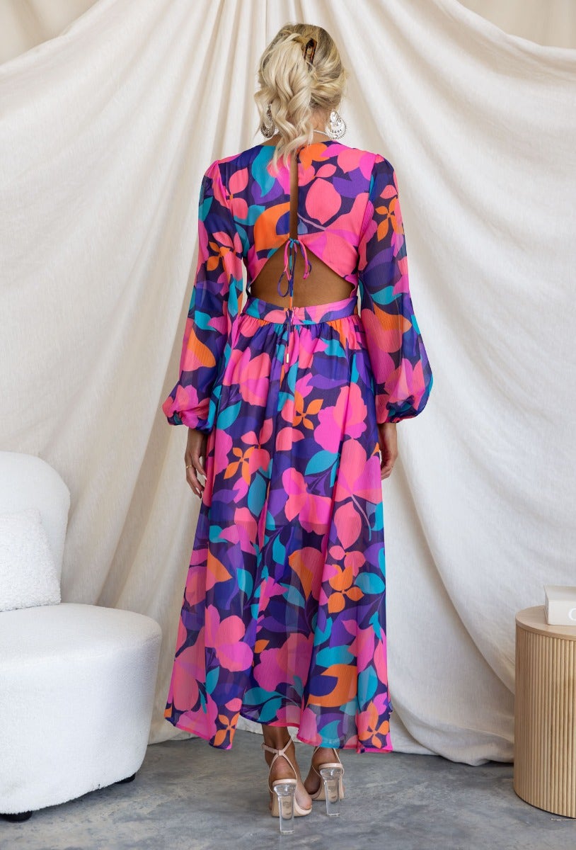 Back view of Romina Maxi Dress featuring vibrant floral print, cut-out waist, and tie detail.