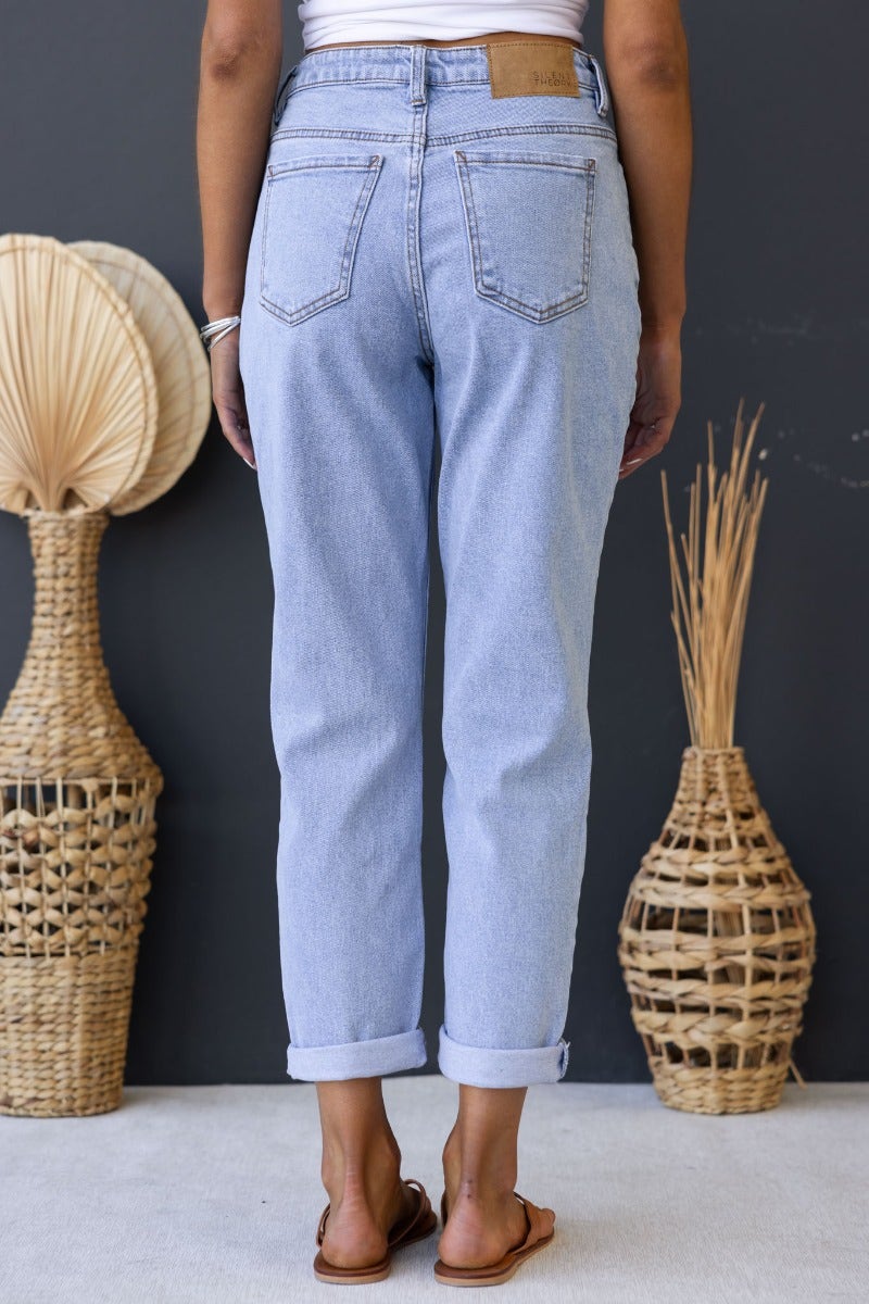 Back view of Dori Mom Jeans in light wash denim, showcasing mid-high waist, rolled cuffs, and back pockets.