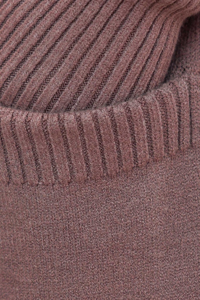 Close-up of the ribbed knit texture of a Motherly Cardigan in soft brown, highlighting the cozy and stretchy fabric.