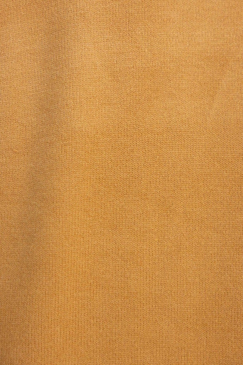 Close-up of ribbed knit fabric in warm mustard color, perfect for cozy garments like the Motherly Cardigan.