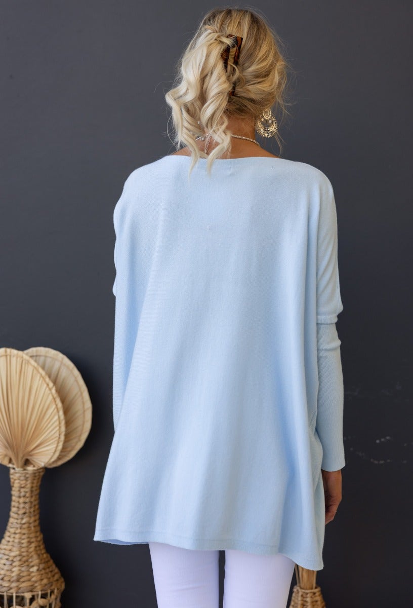 Back view of the Bonnie Knit, a cosy oversized light blue top with full-length sleeves, ideal for layering.