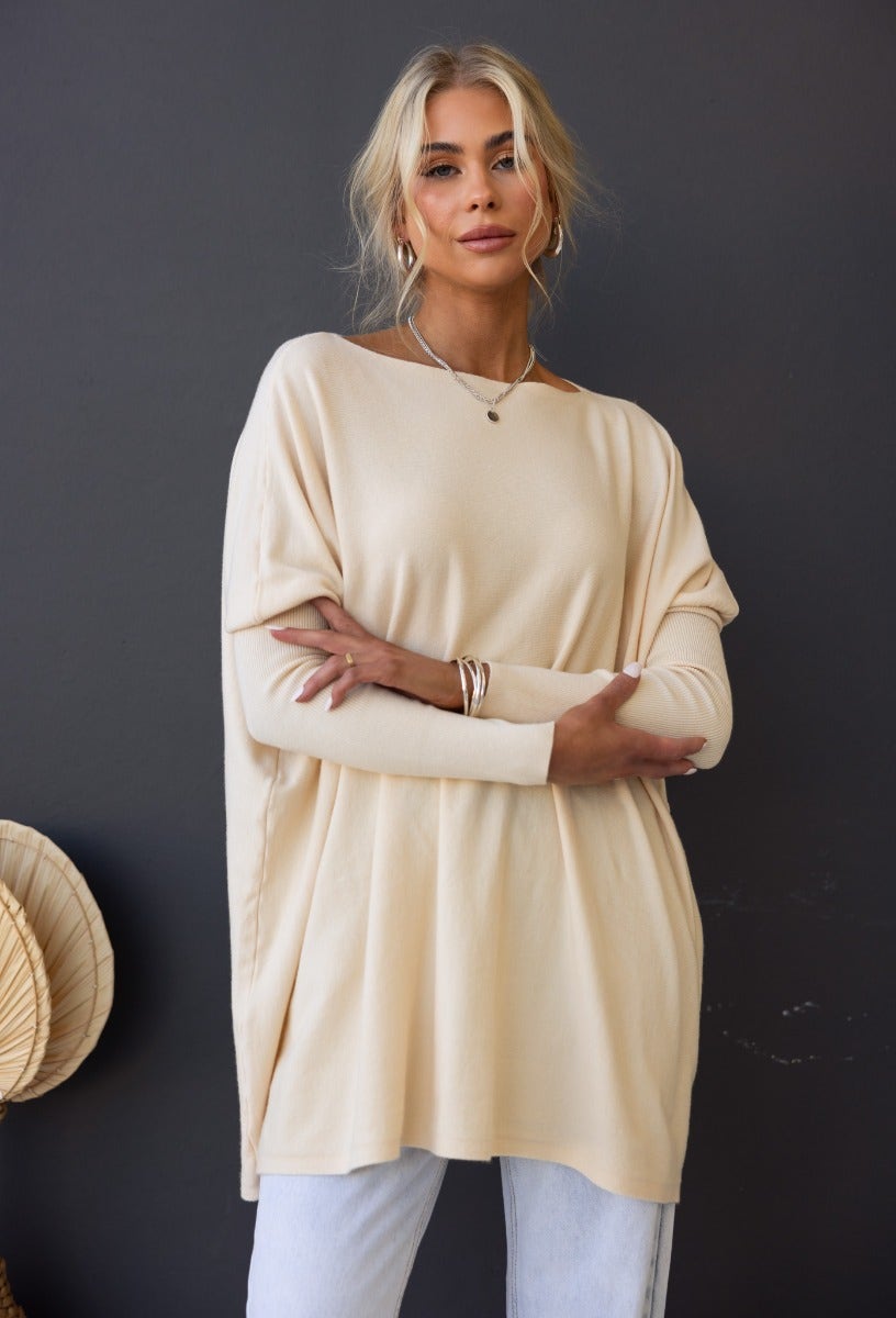 Model wearing a beige oversized Bonnie Knit top with full length sleeves, styled casually for a relaxed look.