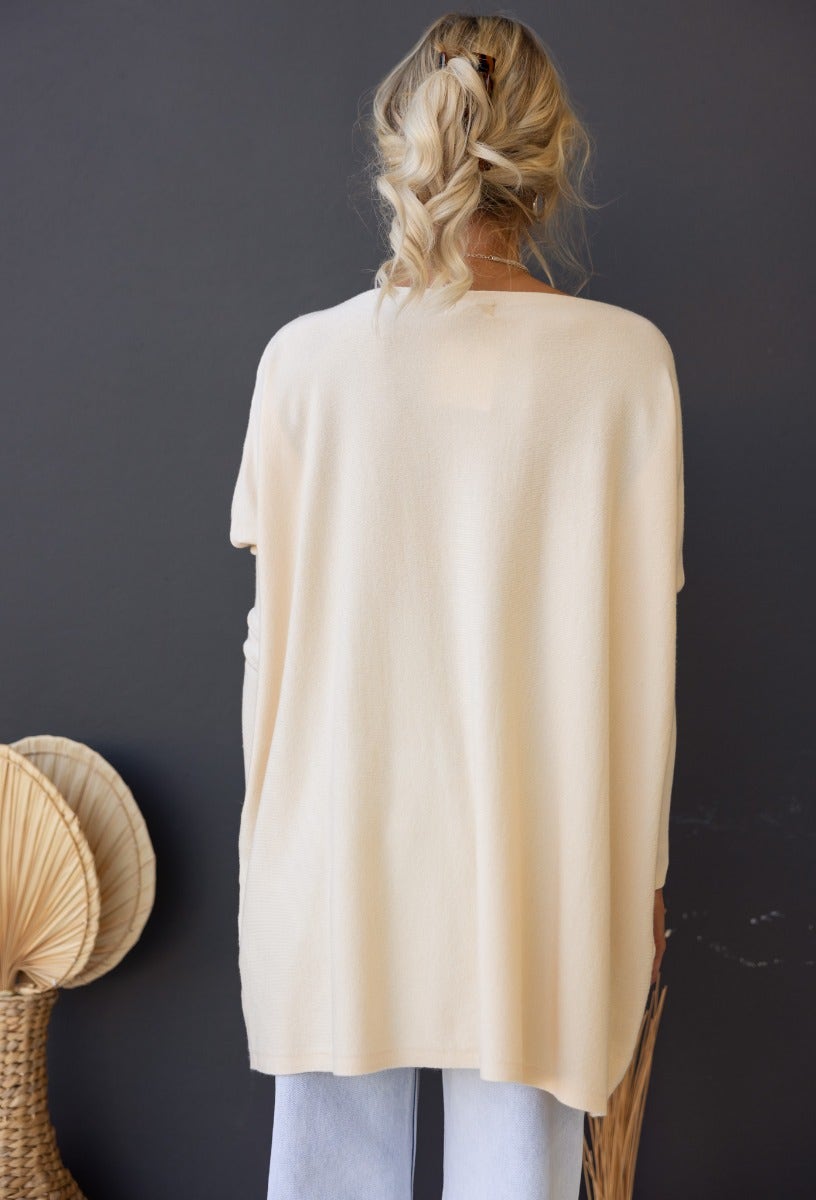 Back view of the Bonnie Knit oversized top in cream, showcasing its relaxed fit and full-length sleeves.
