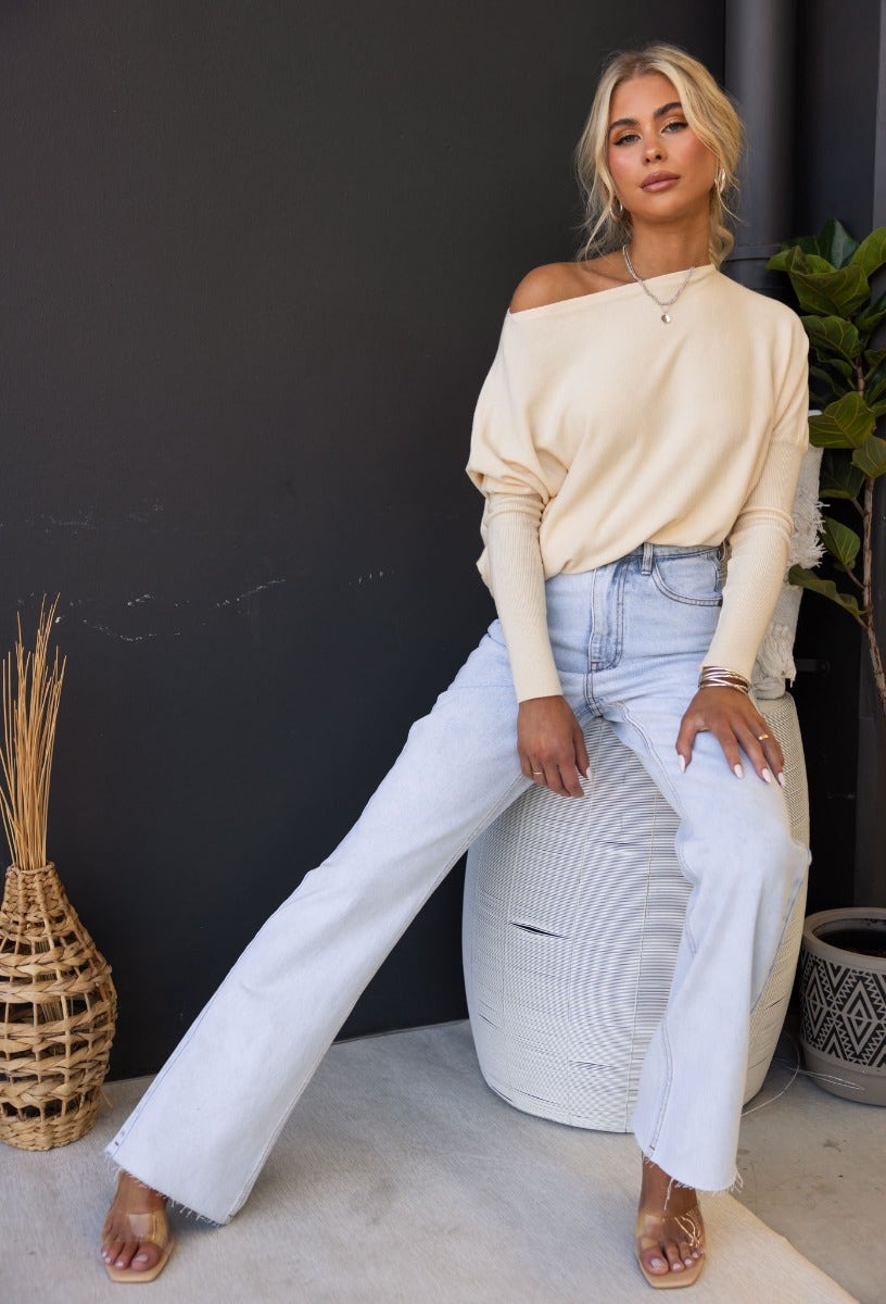 Model wearing a cozy oversized Bonnie Knit top with full sleeves and light denim jeans, styled for a casual look.
