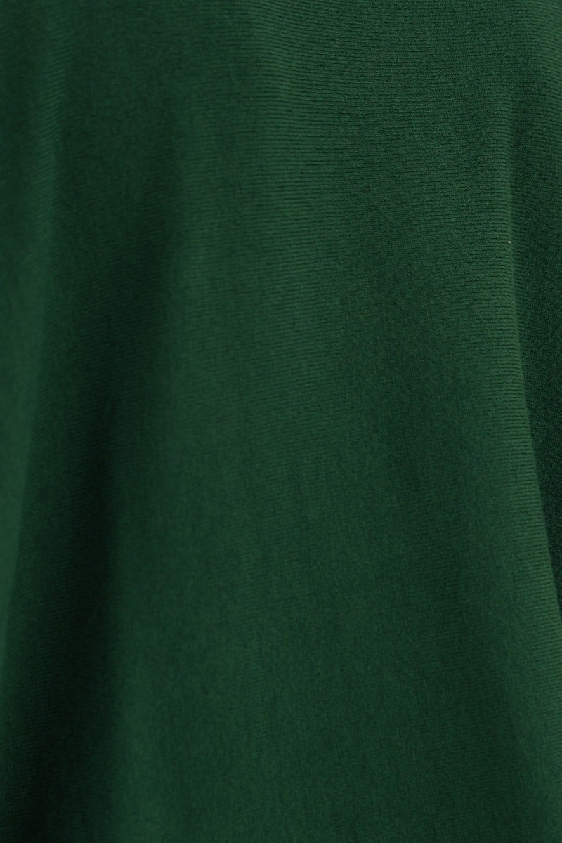 Close-up of Bonnie Knit fabric in dark green, showcasing its soft, stretchy texture for a cozy oversized top.