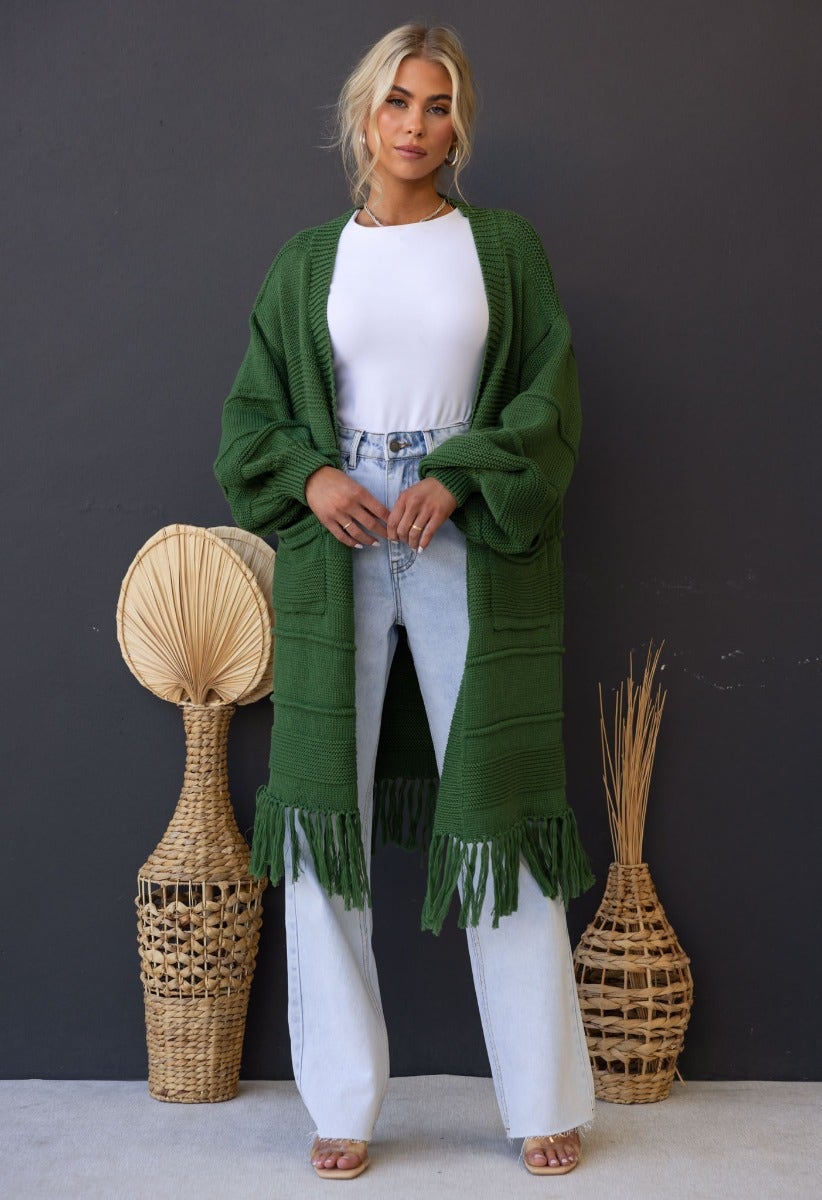 Zeddie Cardigan in green, longline knit style with pockets, paired with high-waisted jeans, perfect for casual wear.