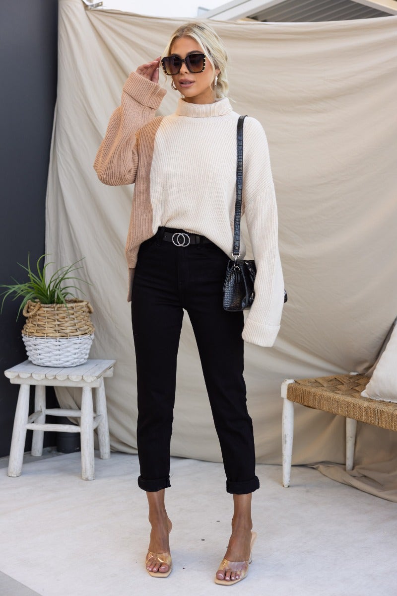 Model wearing Rueben Mom Jeans with a stylish sweater and sunglasses. Perfect for casual fashion styles.